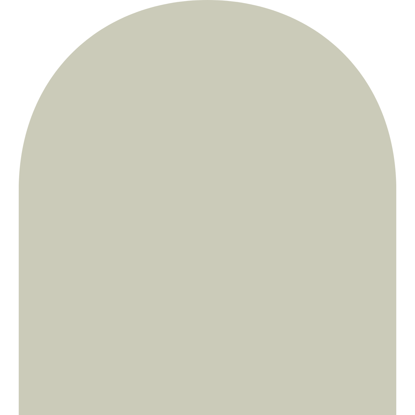 A tombstone with an arched top, light-colored stone surface, and no visible inscriptions.