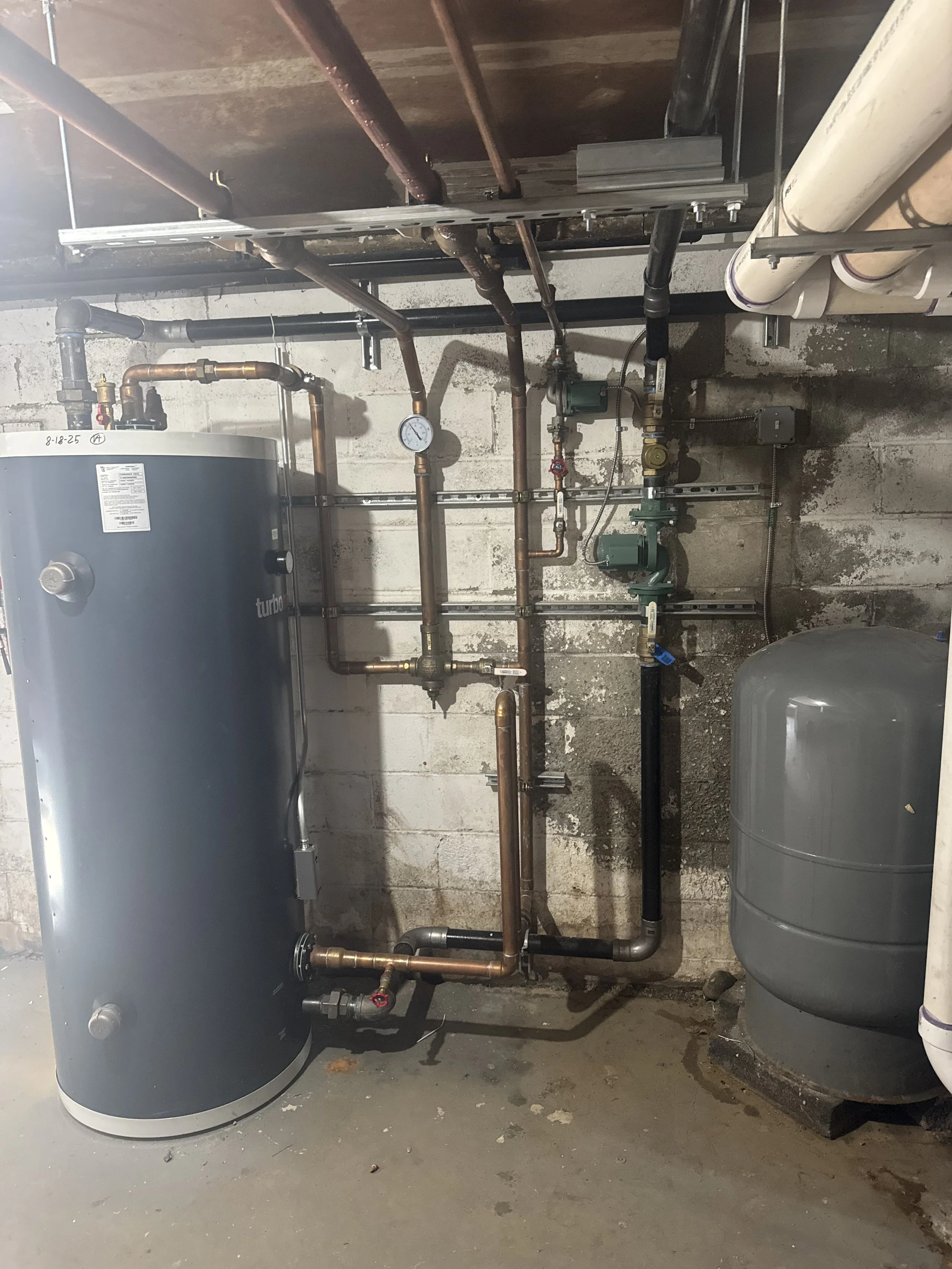 120-gallon Turbomax water heater serving 50 apartments with a 1.6-million-BTU boiler