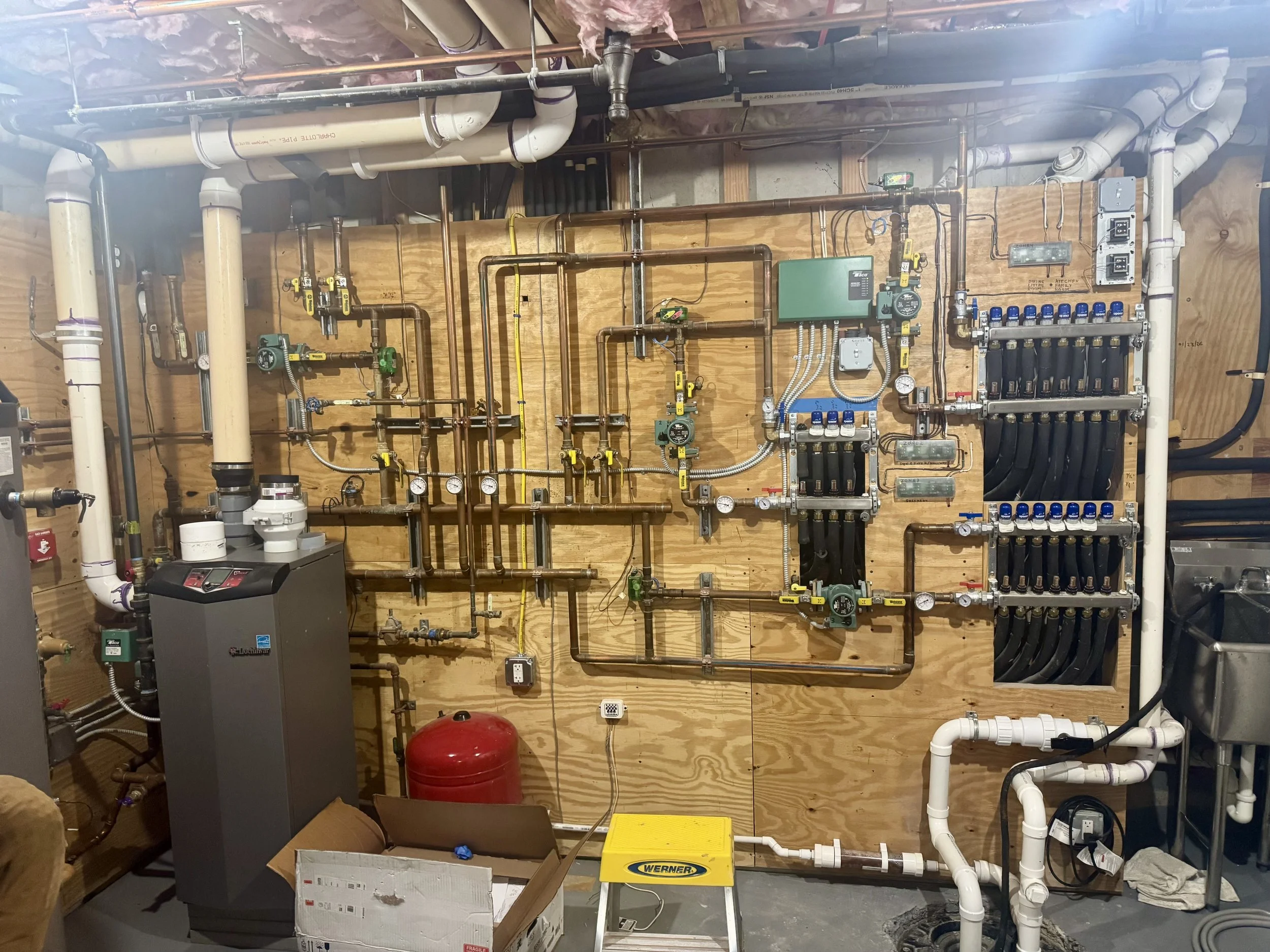 Multi-zone hydronic radiant heating system with boiler controls, pumps and copper piping for a whole house