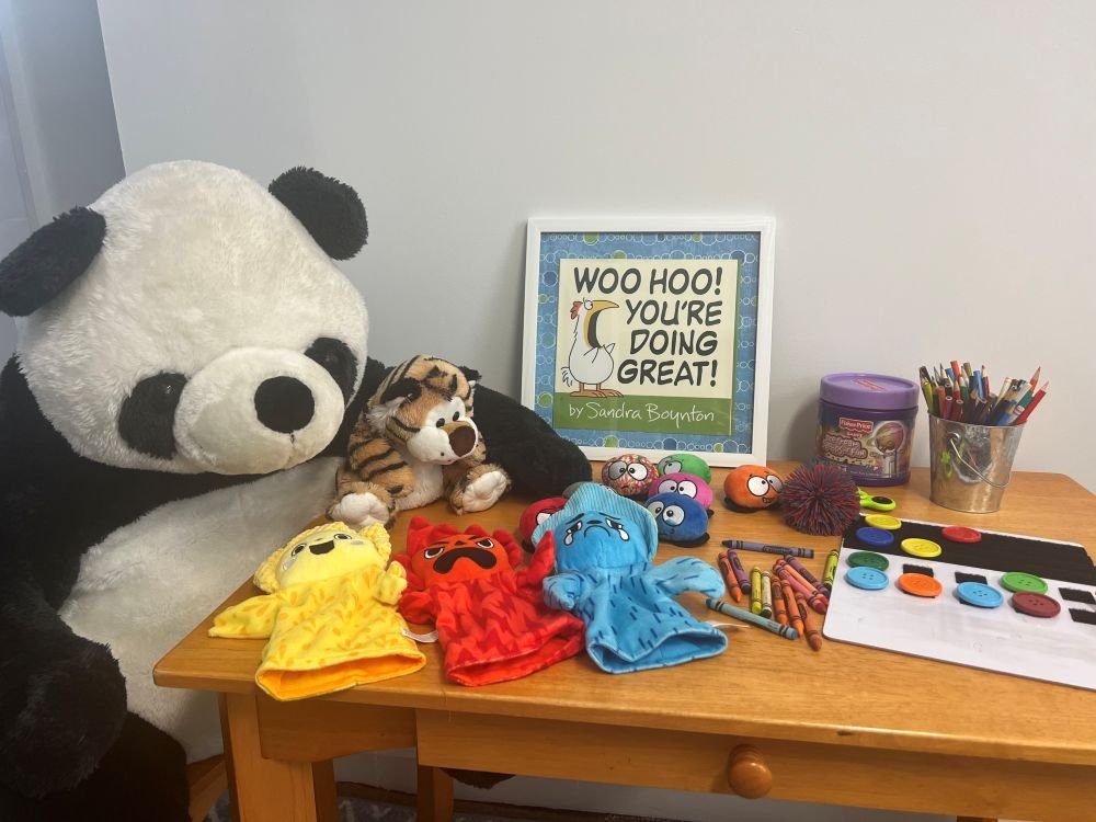 The Mandeville Mental Health kids' resilience training office in Oyster Bay, NY, including crayons, stuffed animals, and puppets.