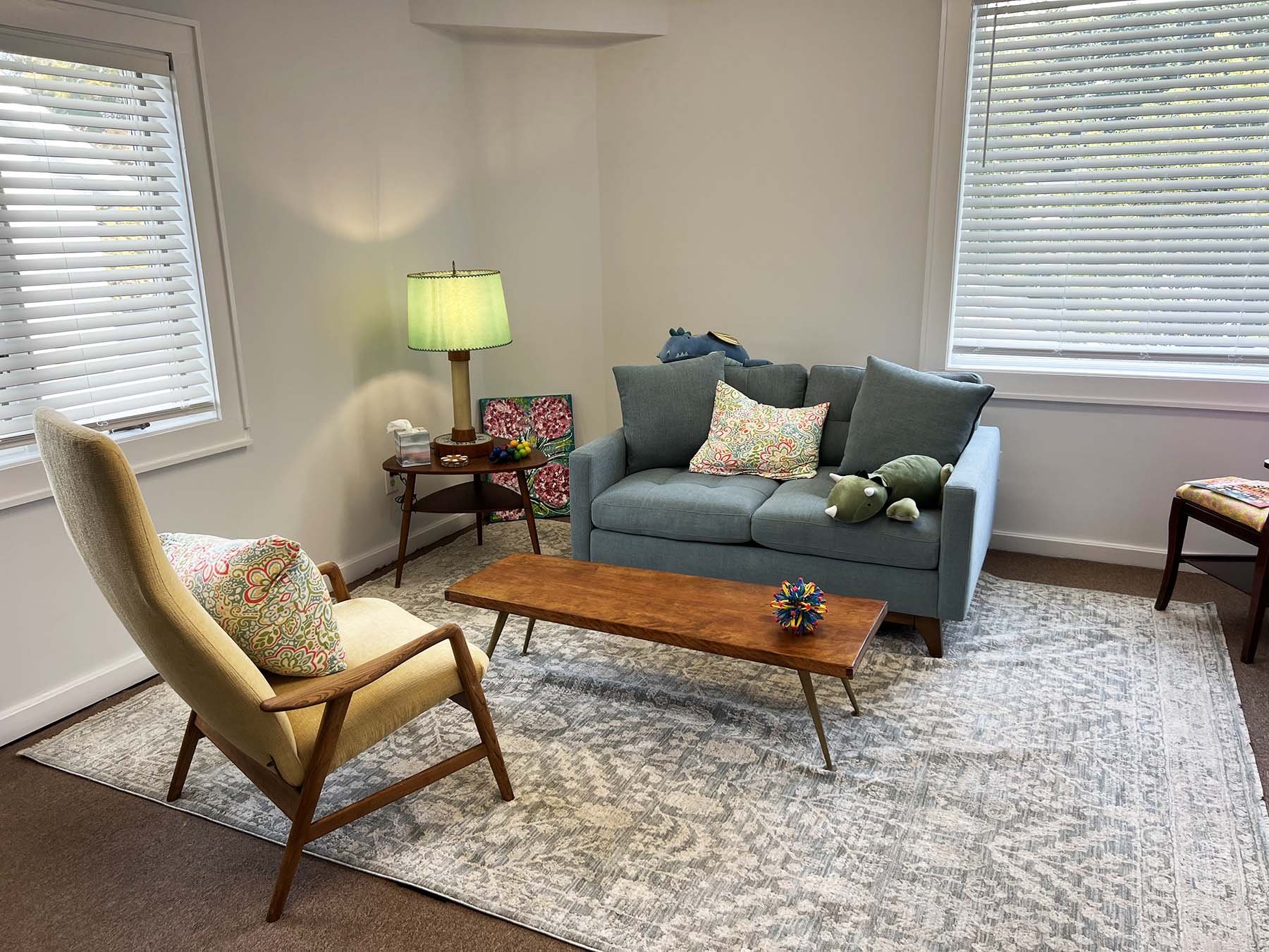 The Mandeville Mental Health Counseling therapy office, featuring a comfy blue couch and bright light.