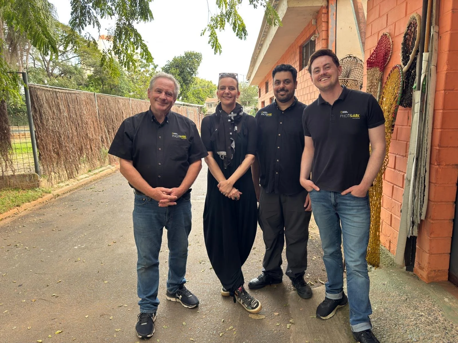 Joel Sartore, Cole Sartore, Nayer Youakim, and Tatiane Feres stand for a photo after working for the Photo Ark at the Sao Paulo Zoo in São Paulo, Brazil.