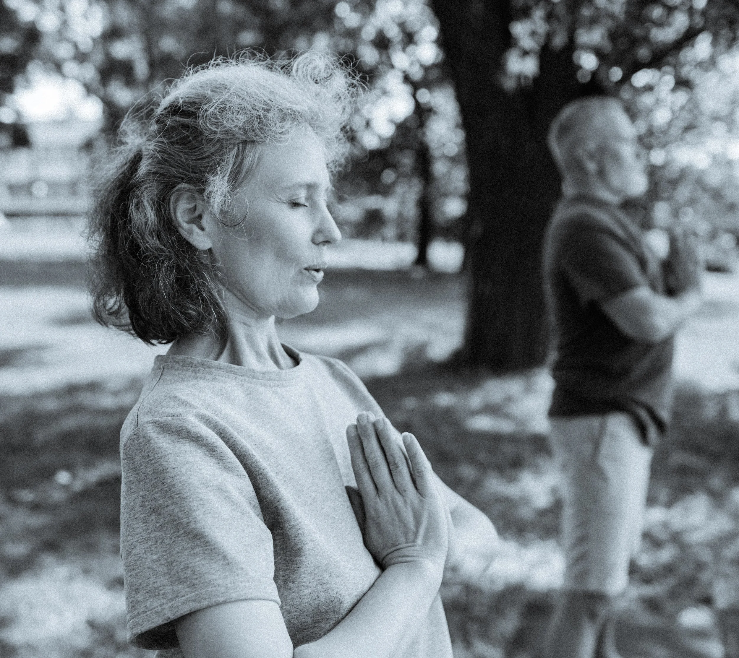 Outdoor yoga practice in nature with seniors meditating in prayer pose – Eternal Now Yoga, Estero Florida.