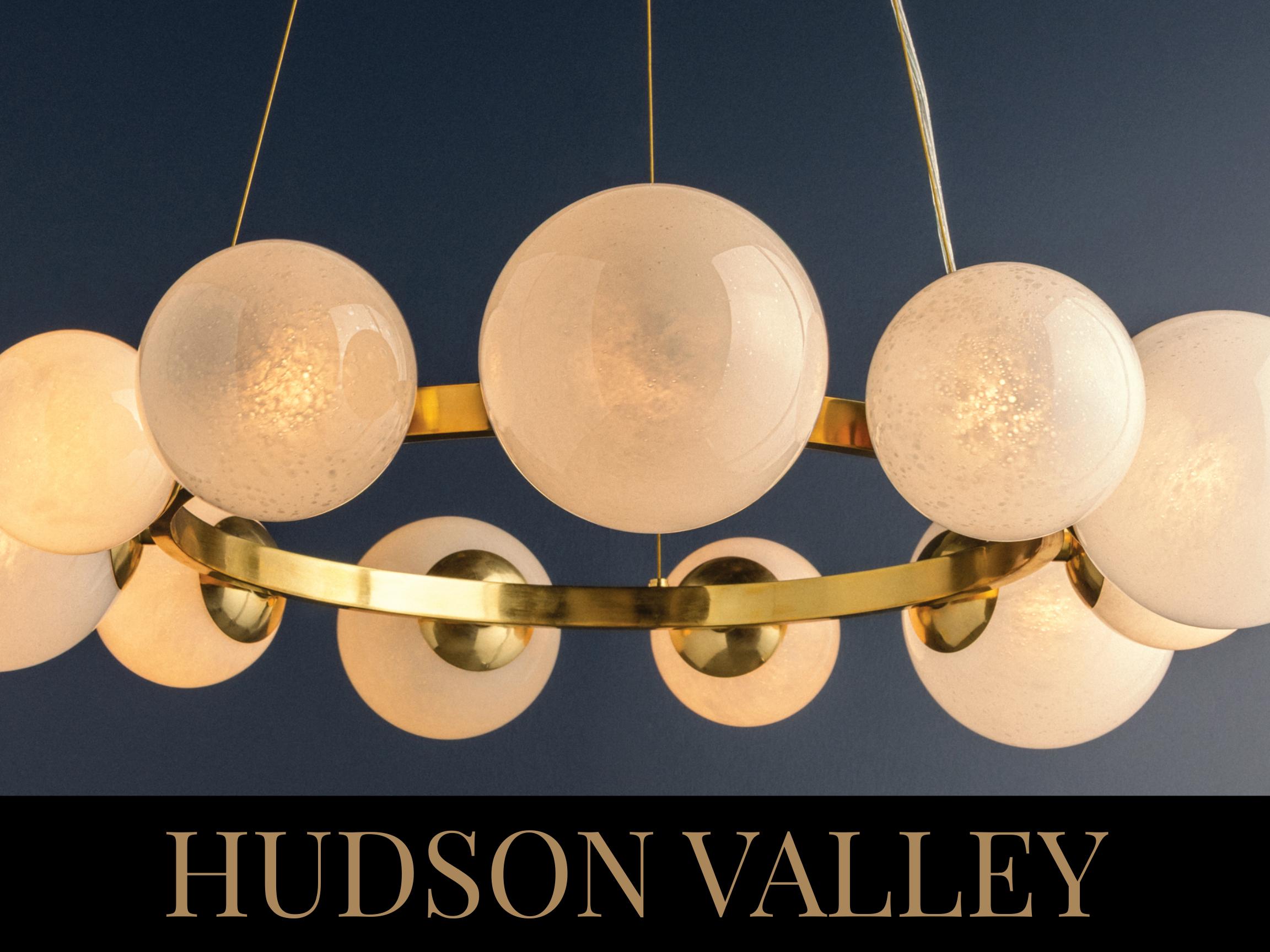 A chandelier with multiple round white glass globes and a gold ring hanging from the ceiling against a dark blue background, with the text 'HUDSON VALLEY' at the bottom.