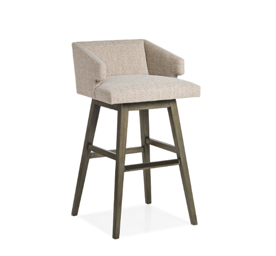 A bar stool with a cushioned beige fabric seat and backrest, and wooden legs.