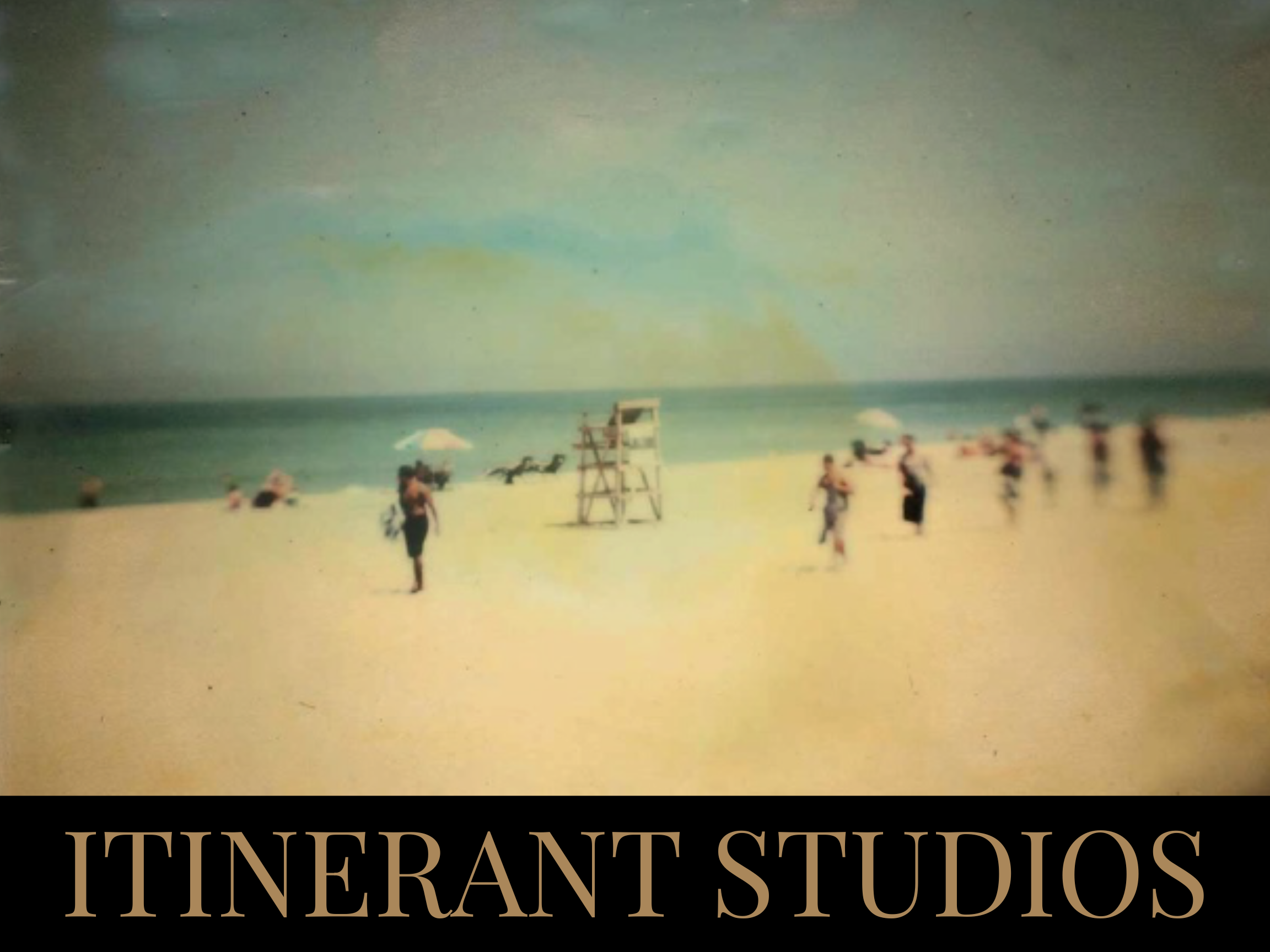 A vintage color photograph of a beach scene with people, umbrellas, and a lifeguard stand, with 'ITINERANT STUDIOS' written at the bottom.