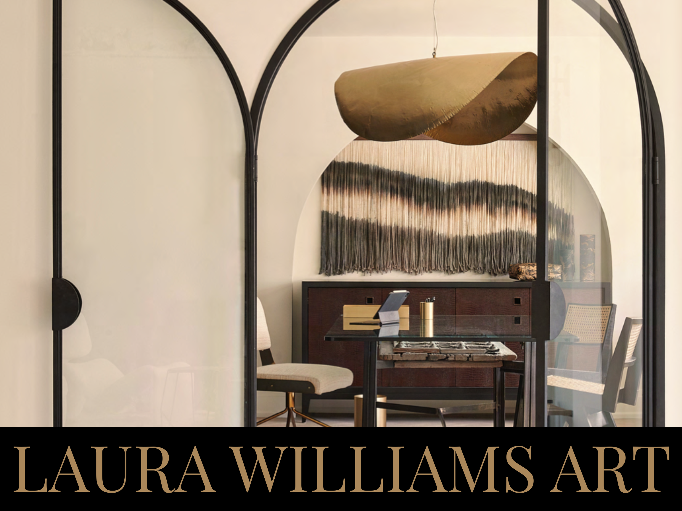 Interior of a modern room with a glass table, white and beige chairs, a dark sideboard, large abstract wall hanging, and a sculptural hanging light fixture, viewed through black-framed glass doors. Text overlay says 'LAURA WILLIAMS ART'.