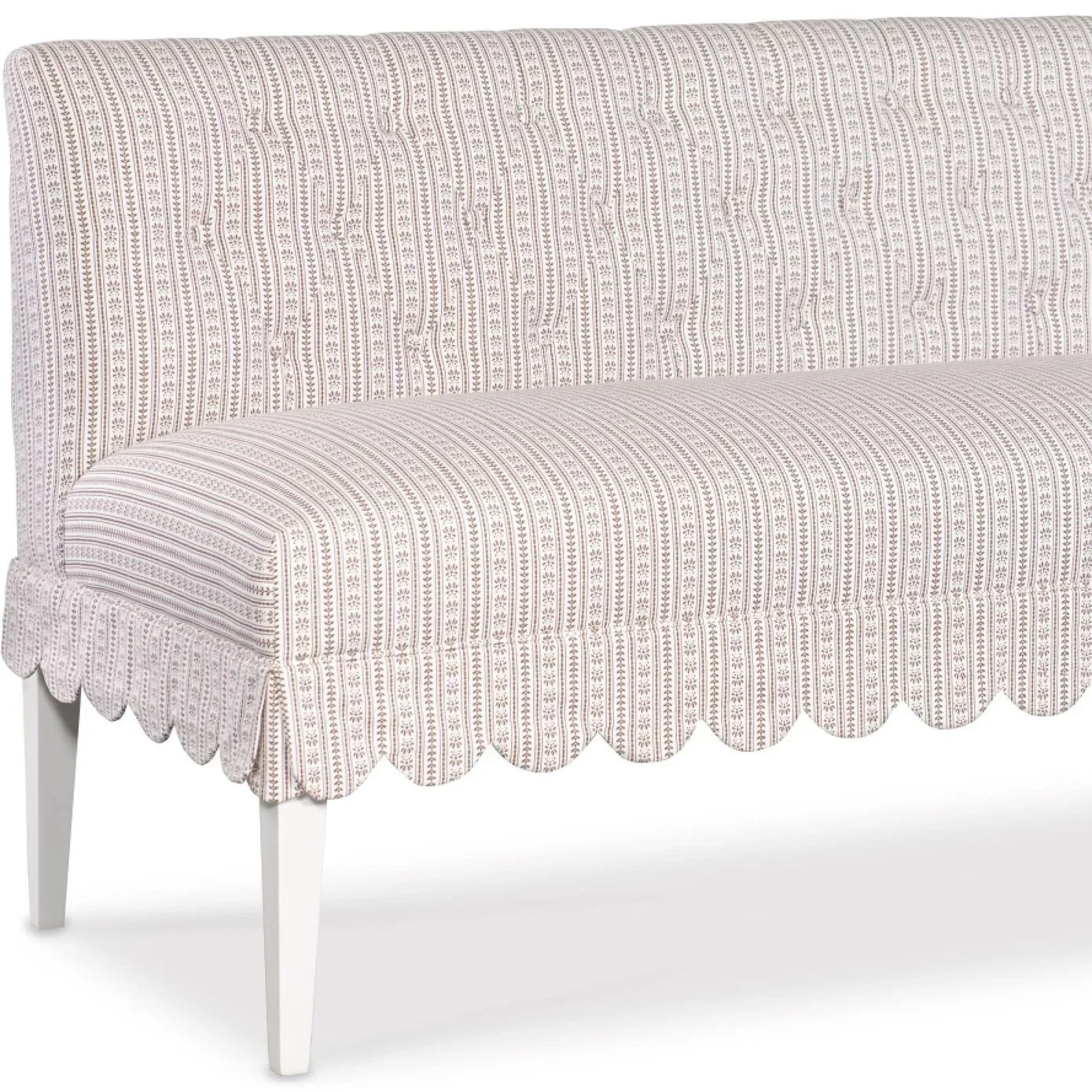 A vintage-style upholstered sofa with a patterned fabric cover and white wooden legs.
