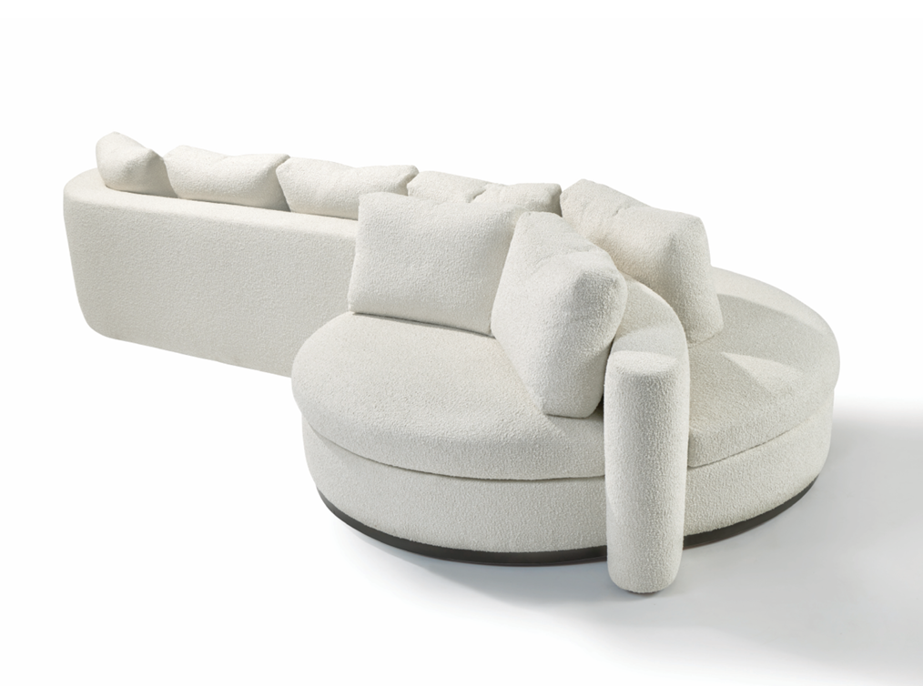 White modern sofa with multiple cushions, rounded design, and textured fabric, placed on a white background.