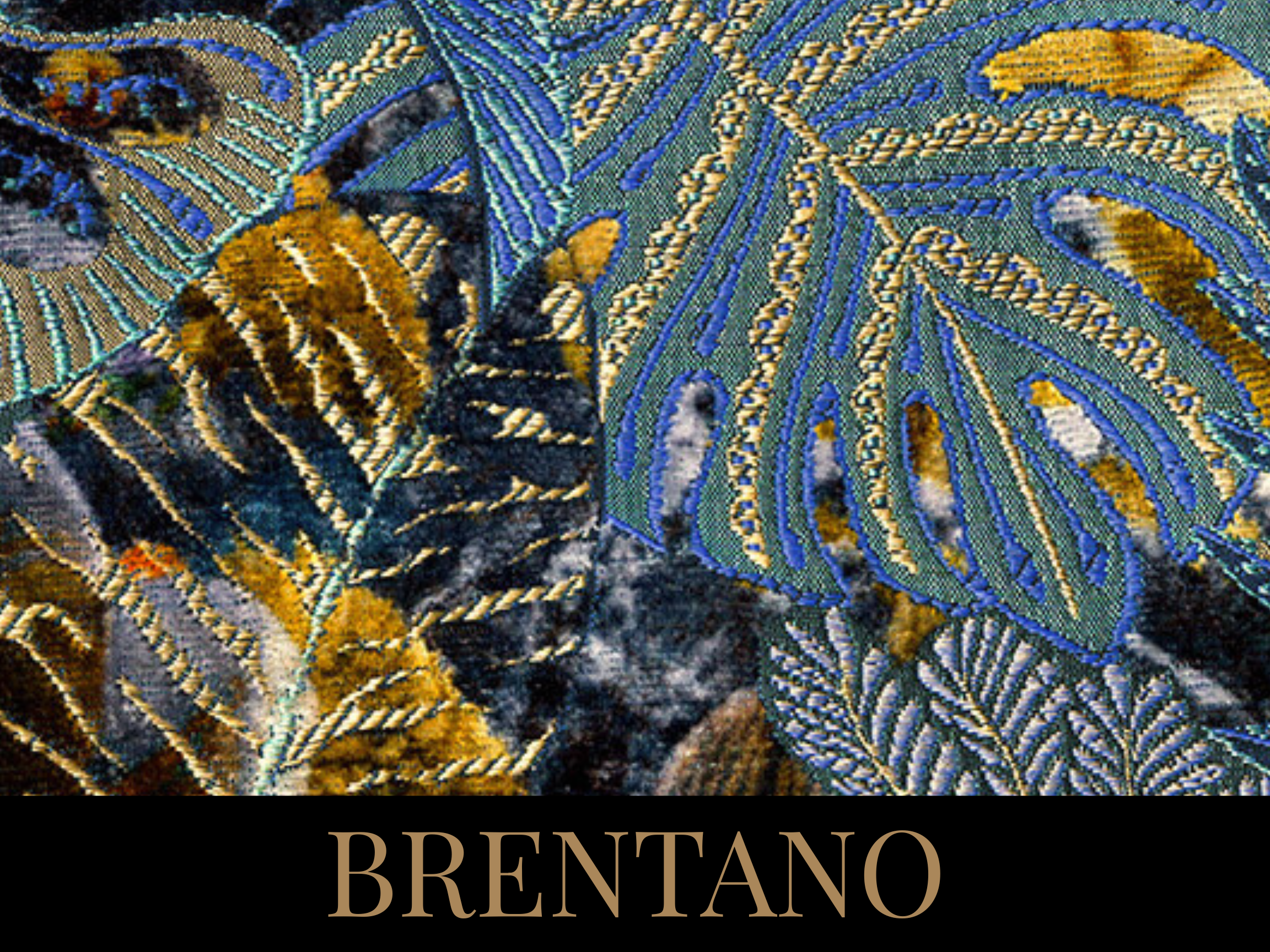 Close-up of embroidered fabric with tropical leaf motifs in yellow, blue, black, and white, with the word "BRENTANO" in beige on a black background at the bottom.