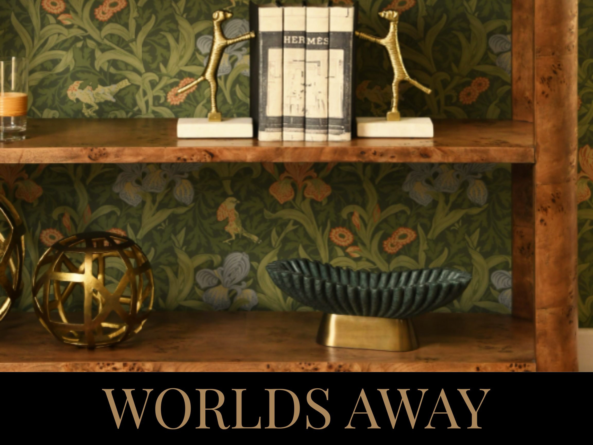 A wooden shelf with decorative objects including a black and gold bowl, geometric gold sphere, decorative bookends with giraffe figures, books, and a small glass with a candle, set against a floral wallpaper background. Text at the bottom reads 'WORL