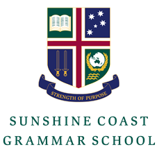 School logo for Sunshine Coast Grammar School featuring a shield with open book, stars, candles, globe, and a banner reading 'Strength of Purpose'.
