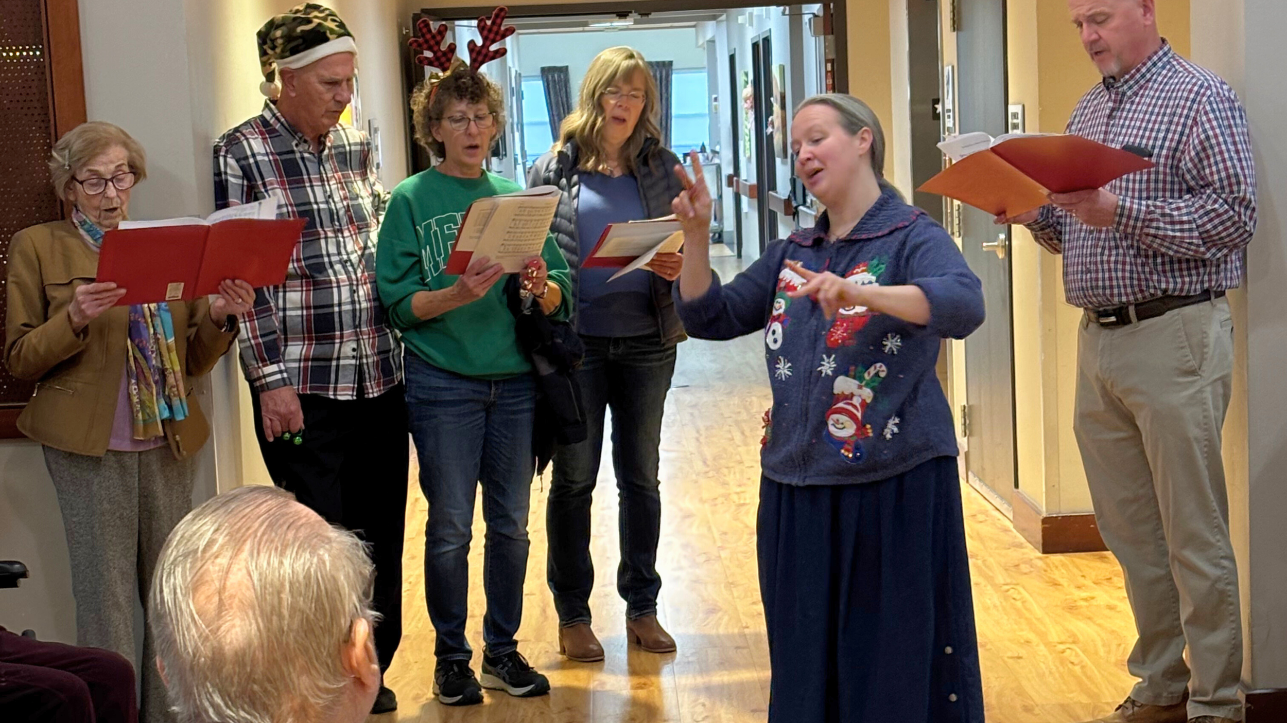 Redeemer Lutheran Church carolers sharing the message of Jesus’ birth with seniors and families, celebrating the Christmas season in faith and song.