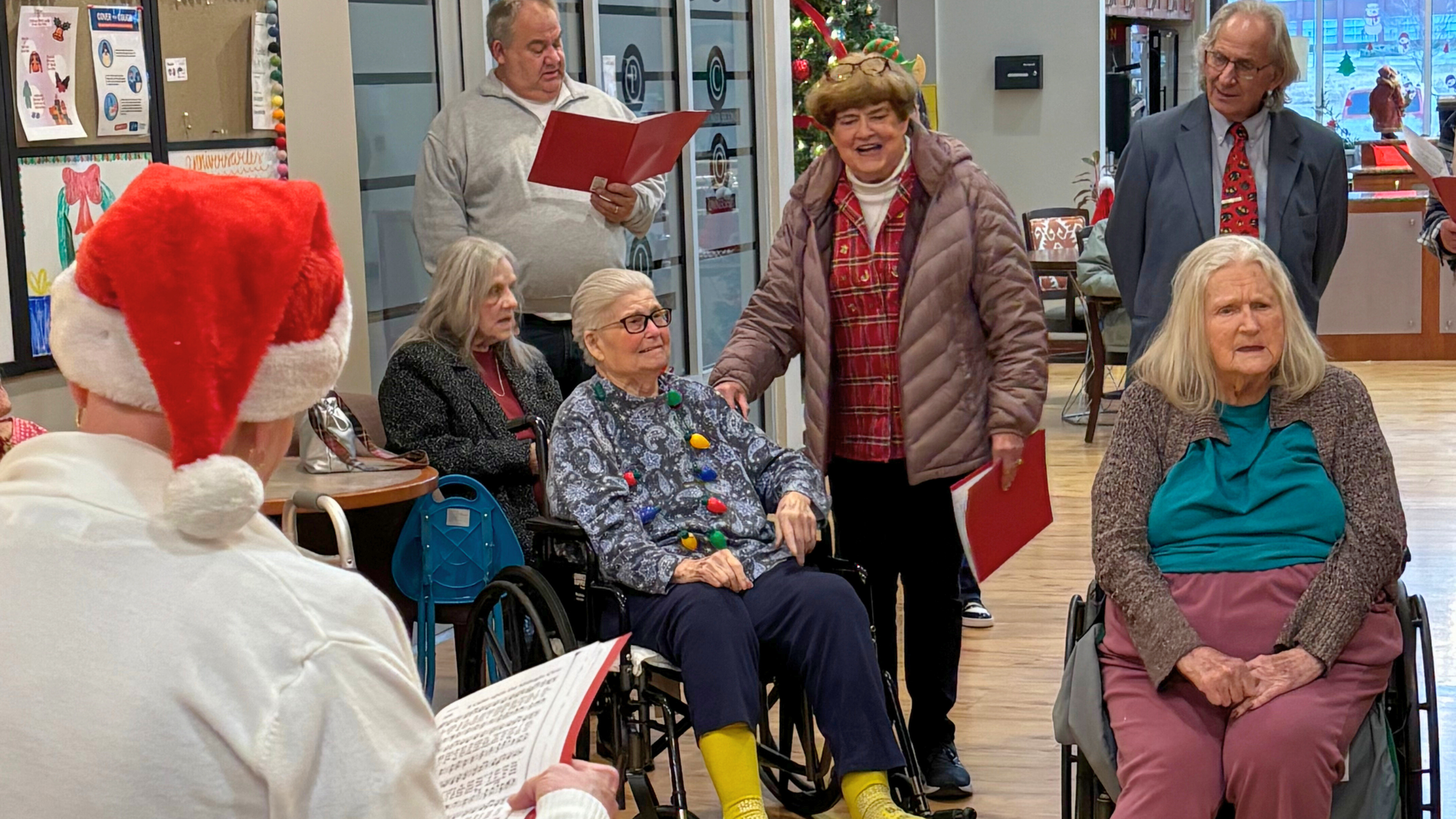 Redeemer Lutheran Church volunteers singing Christmas carols for residents at a nursing home, spreading joy and faith in the community.