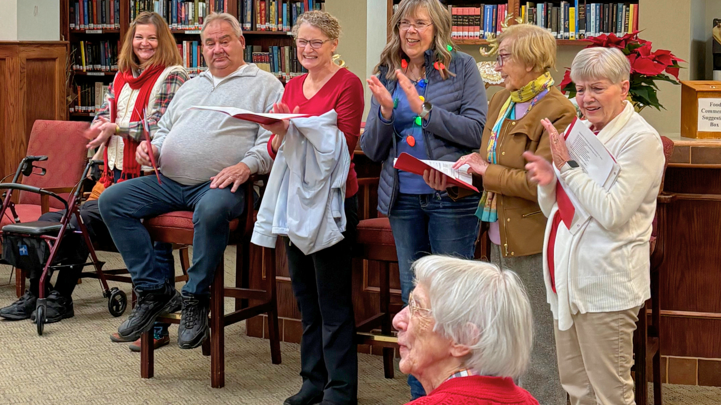 Members of Redeemer Lutheran Church singing joyful Christmas hymns, spreading the love of Christ throughout the local community.