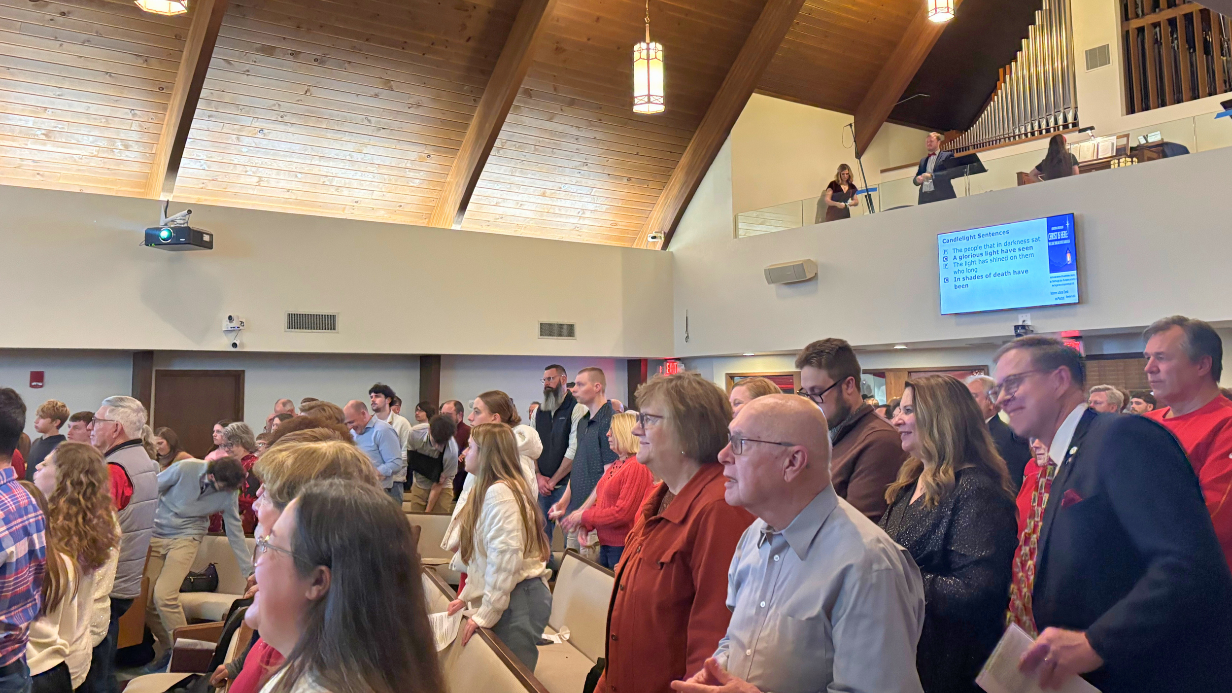 Members of Redeemer Lutheran Church singing hymns together during worship, lifting their voices in praise and celebrating God’s love.