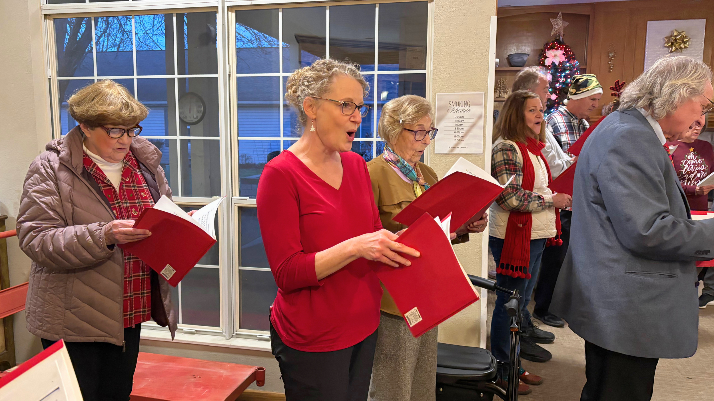 Redeemer Lutheran Church carolers singing for longtime church members at a local nursing home, sharing the joy of Christmas and spreading holiday cheer.