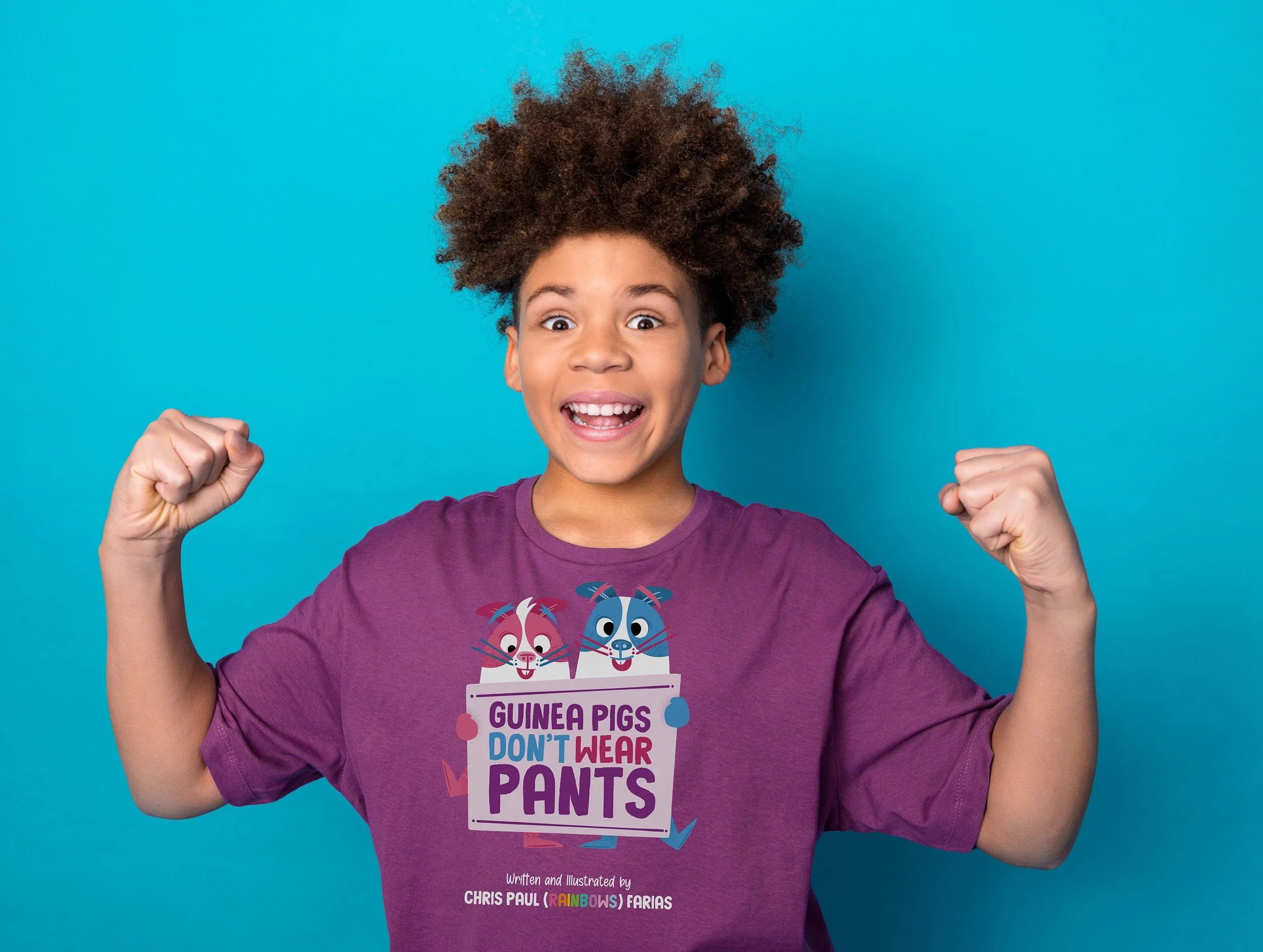 A kid with curly hair raising her fists in a victory pose, wearing a purple shirt with a colorful cartoon guinea pig illustration and a message supporting guinea pigs and protesting against wearing pants.