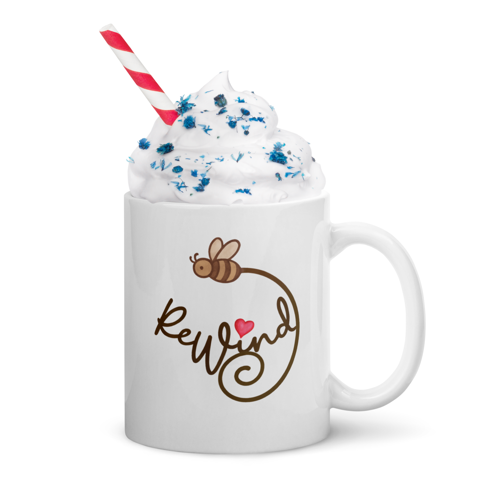 White mug with whipped cream and straw, featuring ReWind script with bee trail and pink heart.