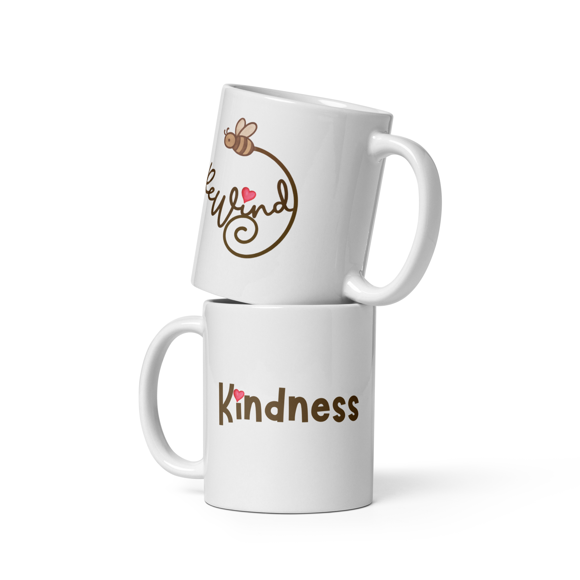 Two white mugs stacked: ReWind bee-trail logo on top mug, “Kindness” with heart-dot on bottom mug.