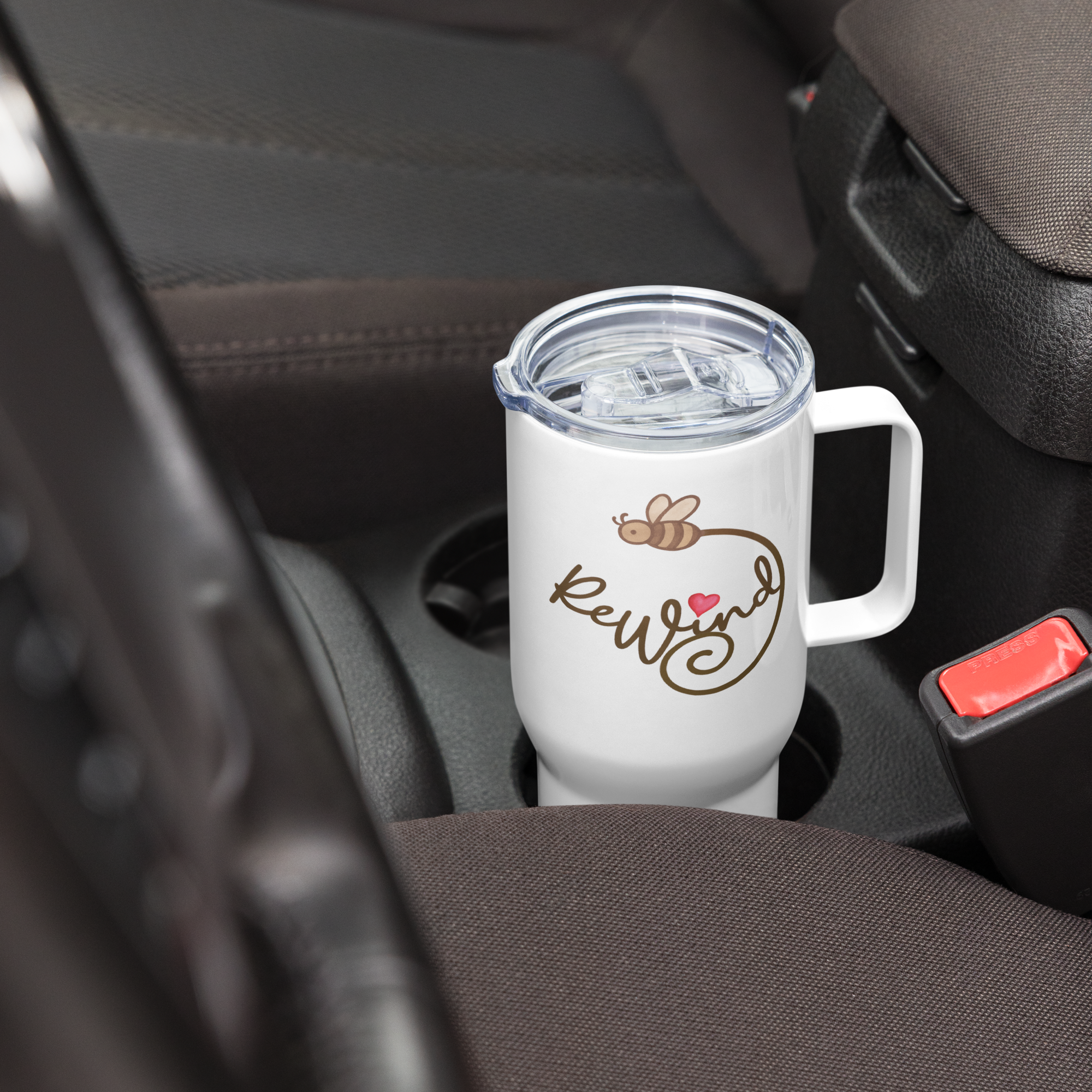 Car cup holder fit: 25-oz white travel mug—ReWind script visible on the cup.