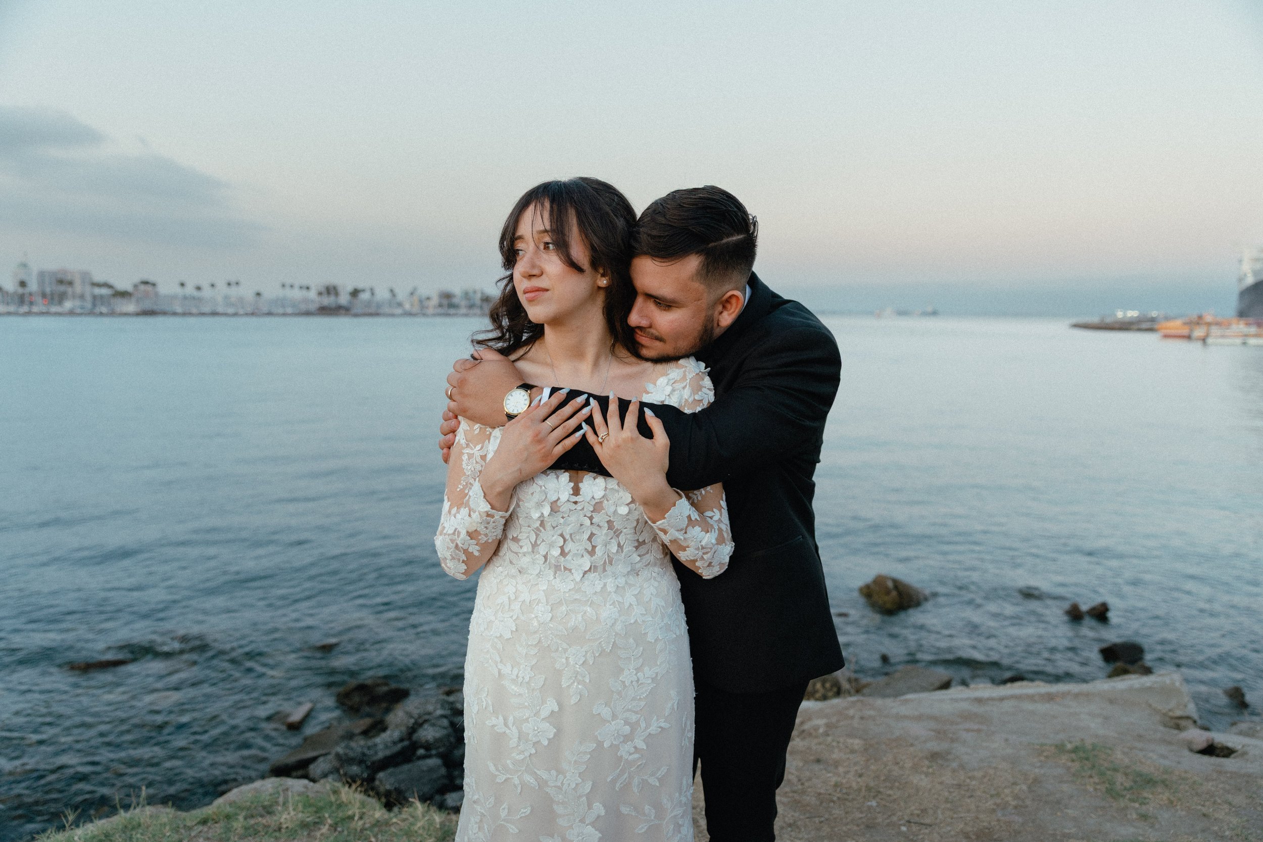 Laurie’s customers, Fernando and Kate embracing by the lake on their wedding day.