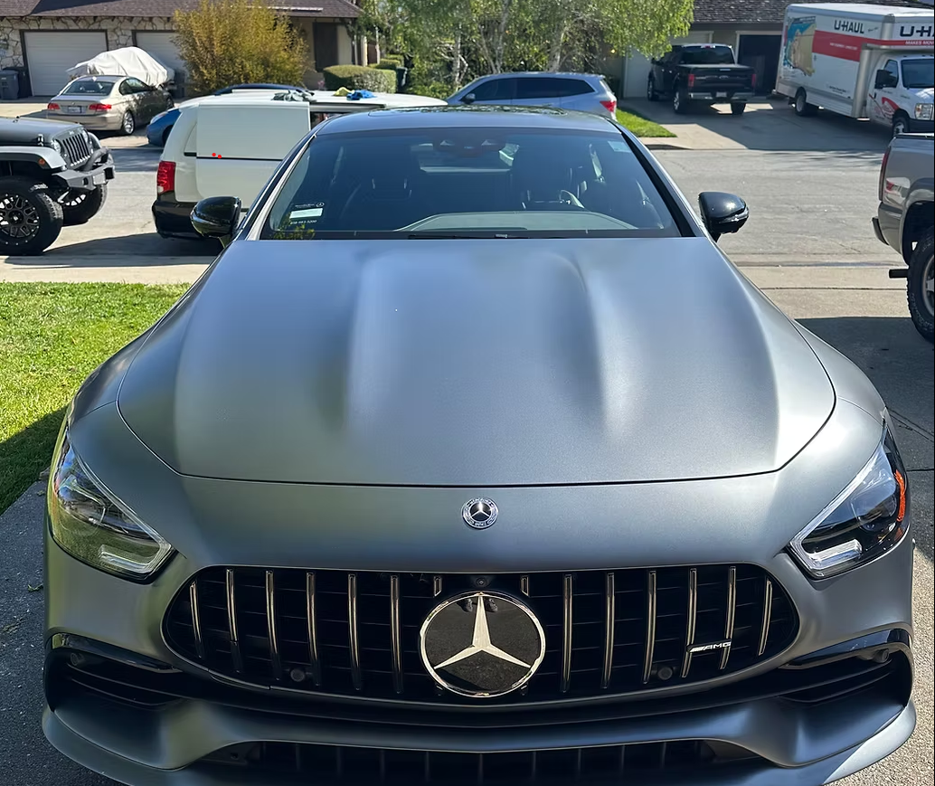 Gray Mercedes-Benz car parked outdoors in a driveway.