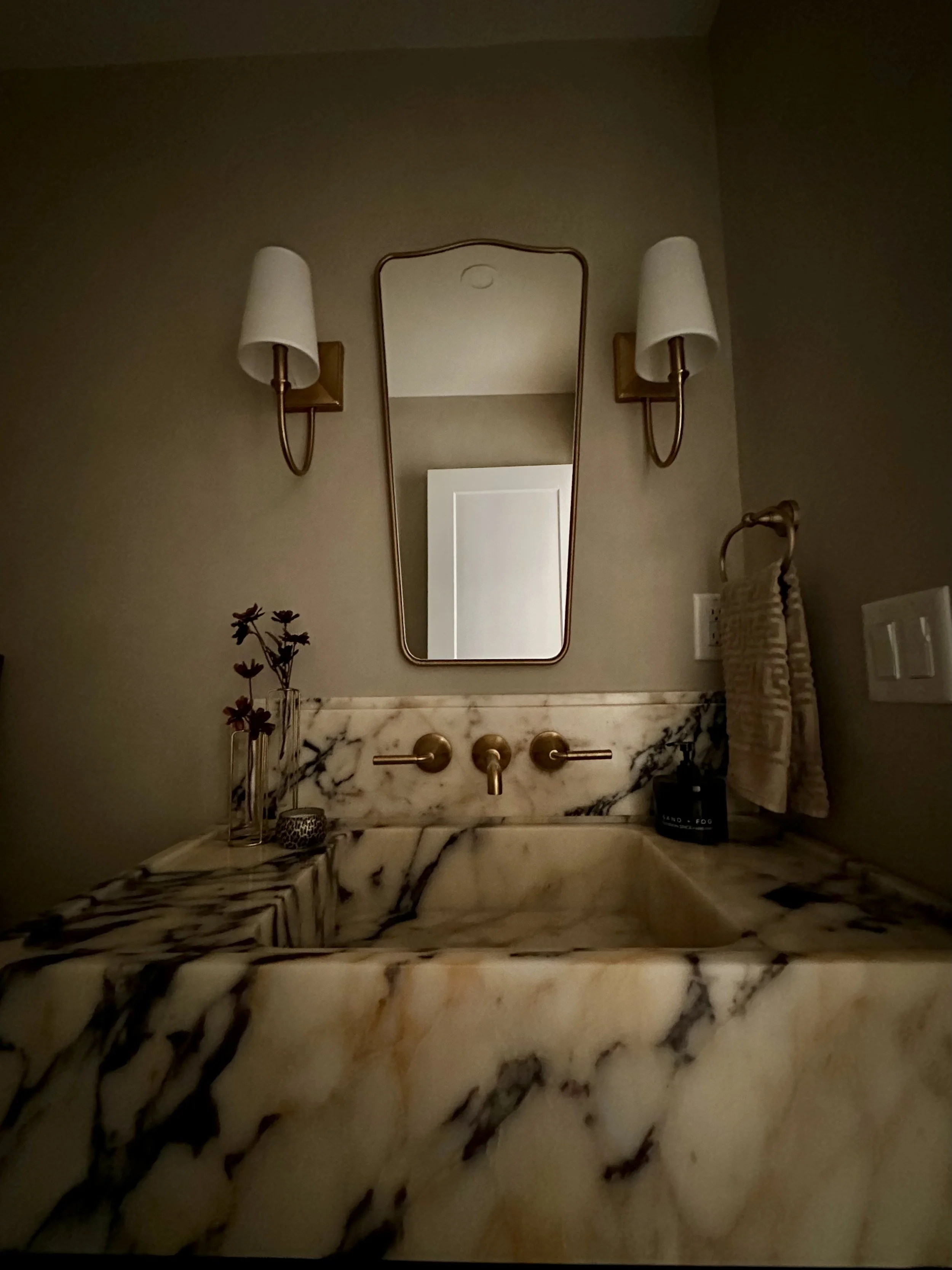 calacatta viola marble vanity with backsplash, gold brass wall mounted faucet, gold narrow mirror, matching sconces with shades, moody limewash walls, modern organic, interior design, bathroom remodel
