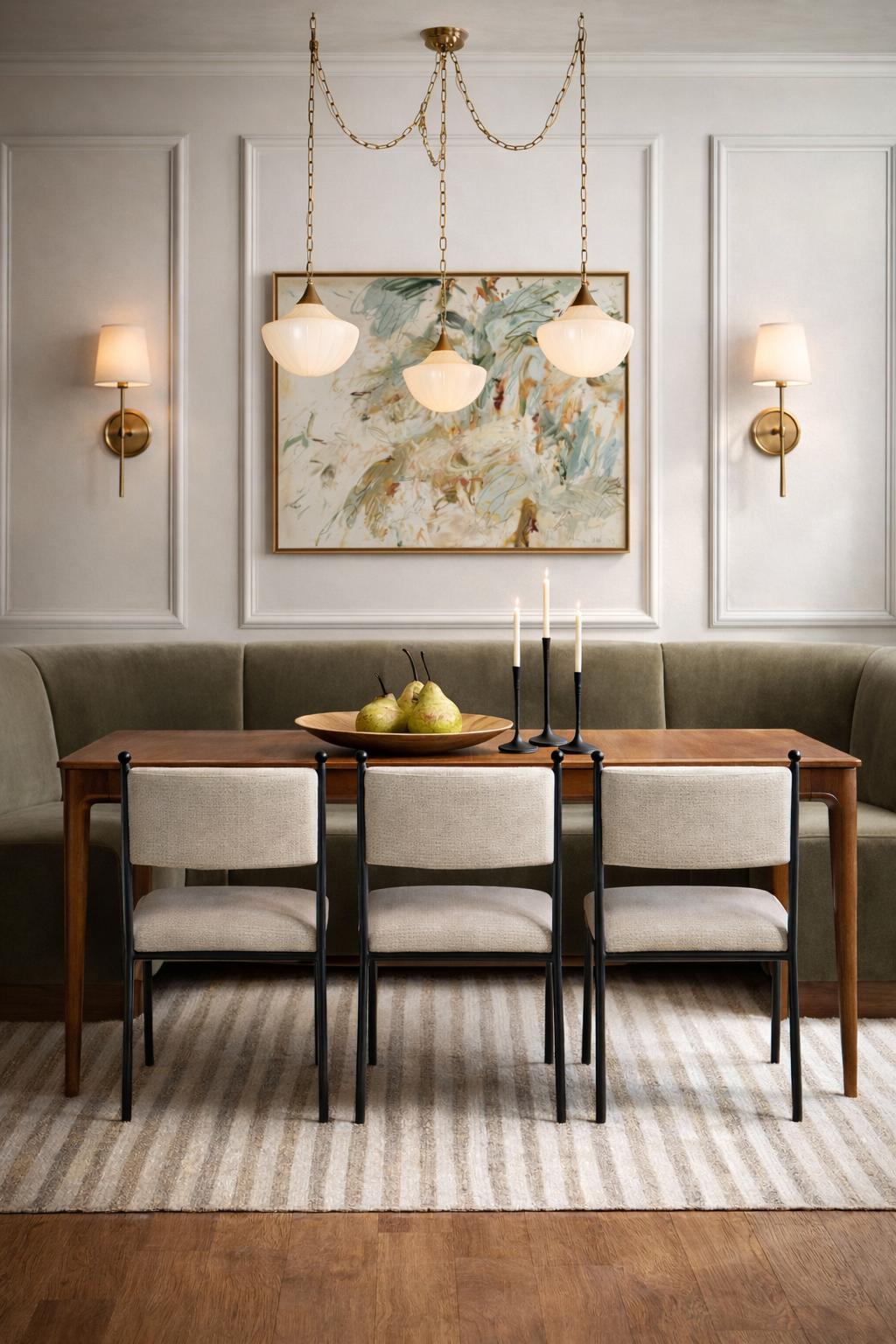 wooden modern traditional dining table, west elm, lulu & georgia upholstered wrought iron dining chairs, striped neutral area rug, abstract muted wall art, picture frame wall molding trim, green olive muted dining banquette nook interior design