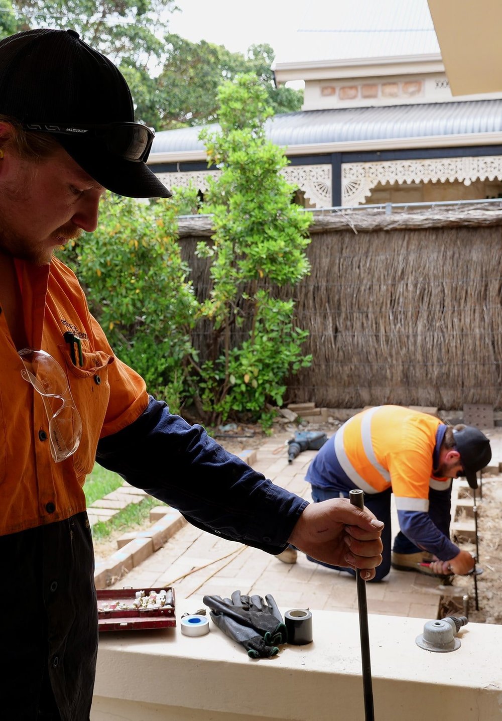 Keyhole injection rods placed beneath a footing for resin injection underpinning