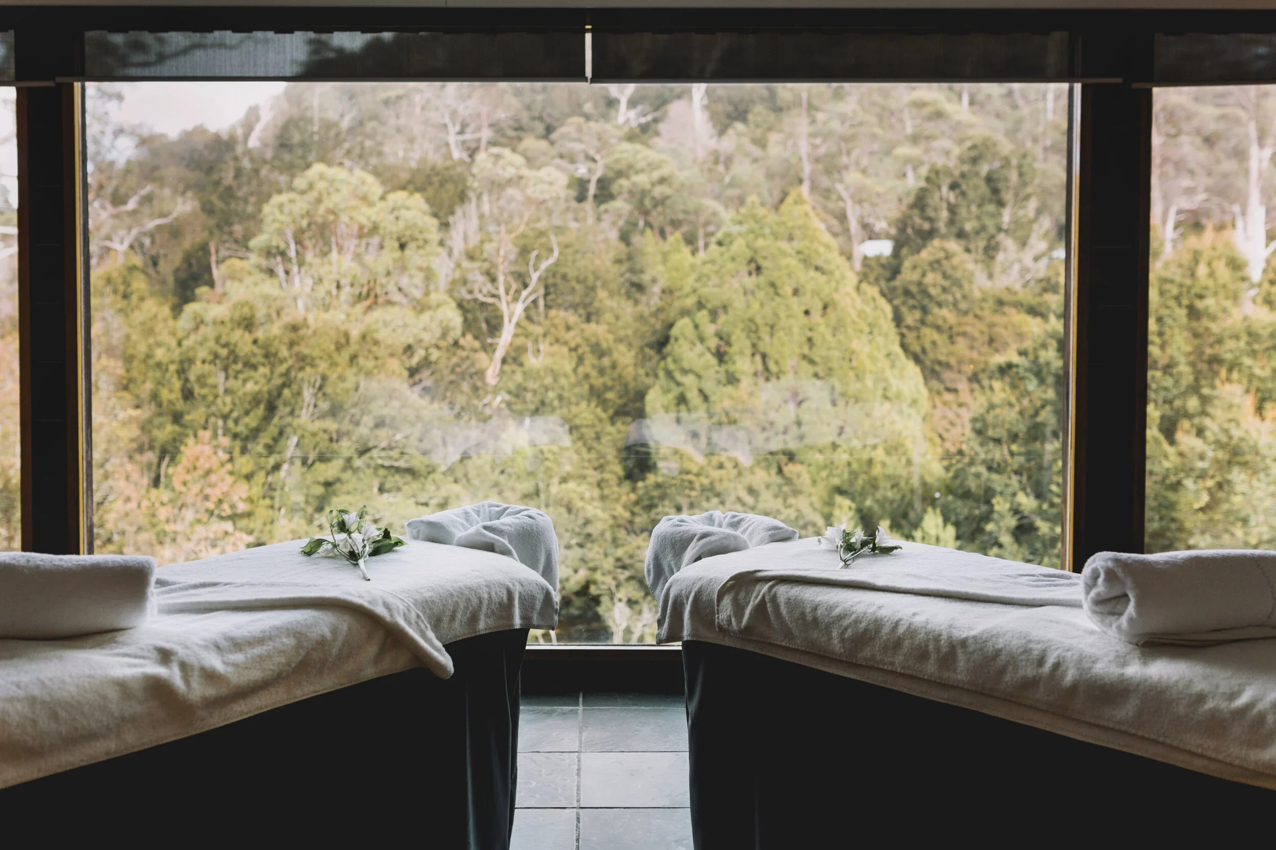 Cradle Mountain Attractions | Cradle Mountain Transfers | Two massage beds in front of forest view