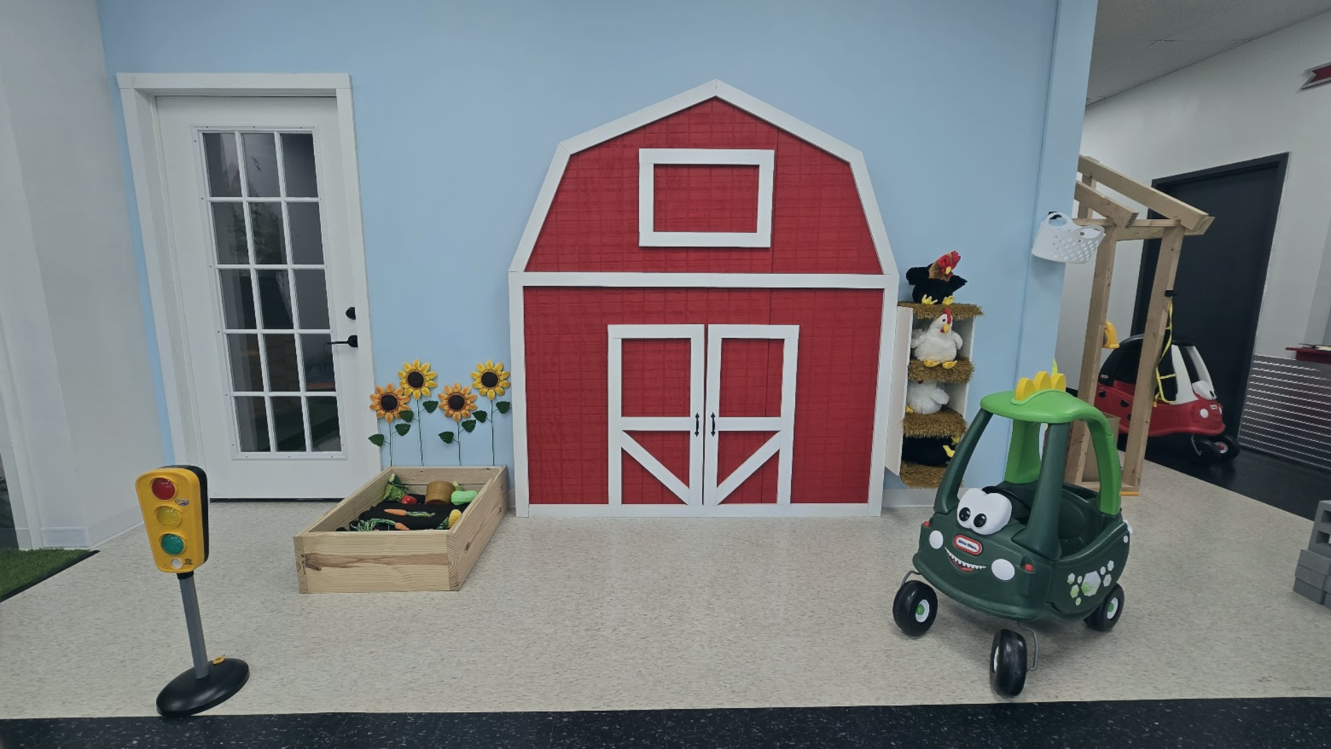 Photo of PlayVille in Brunswick, image of barn, flowers, and play car