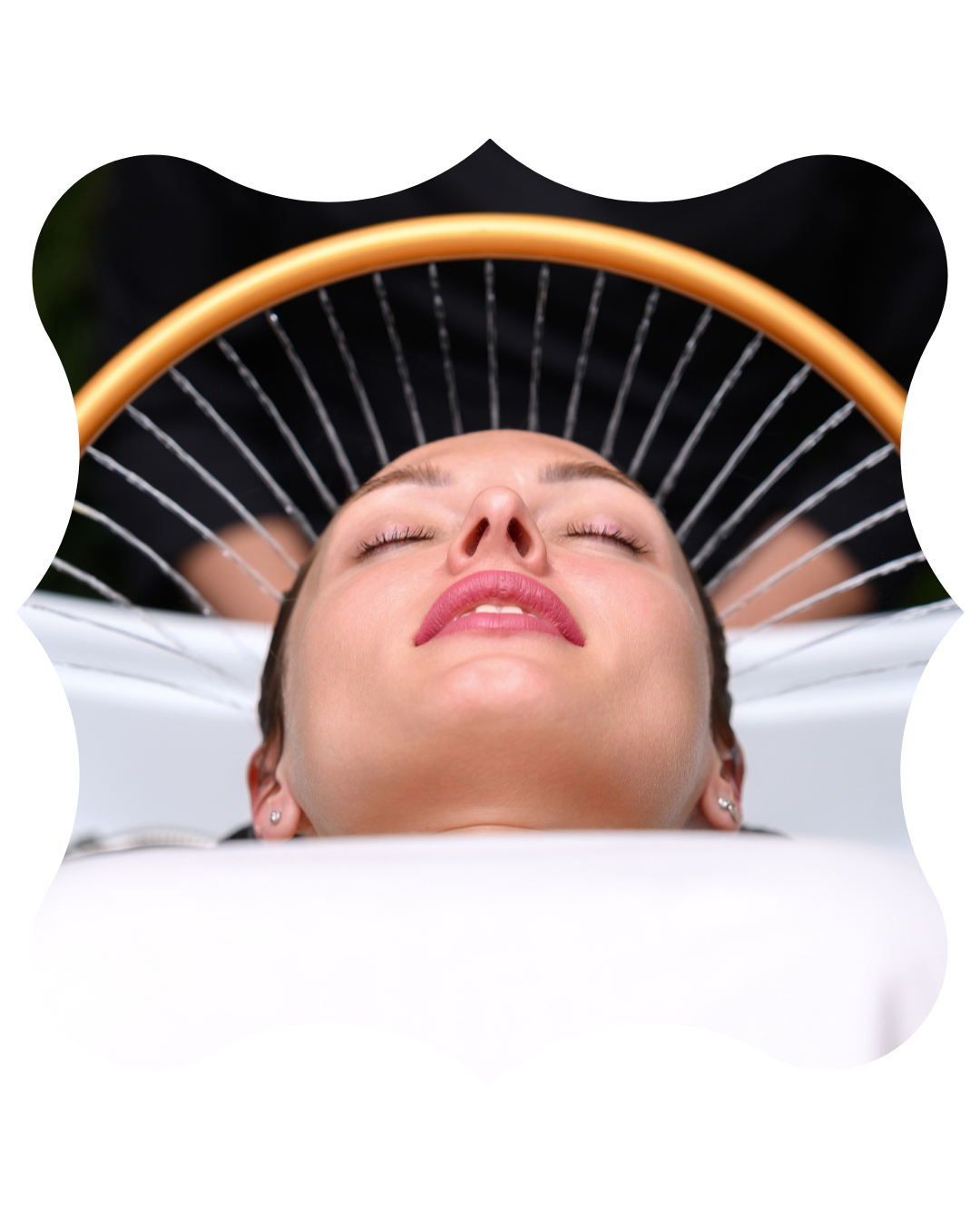 A woman with her eyes closed, relaxing and receiving a Japanese head spa treatment on a head spa bed.