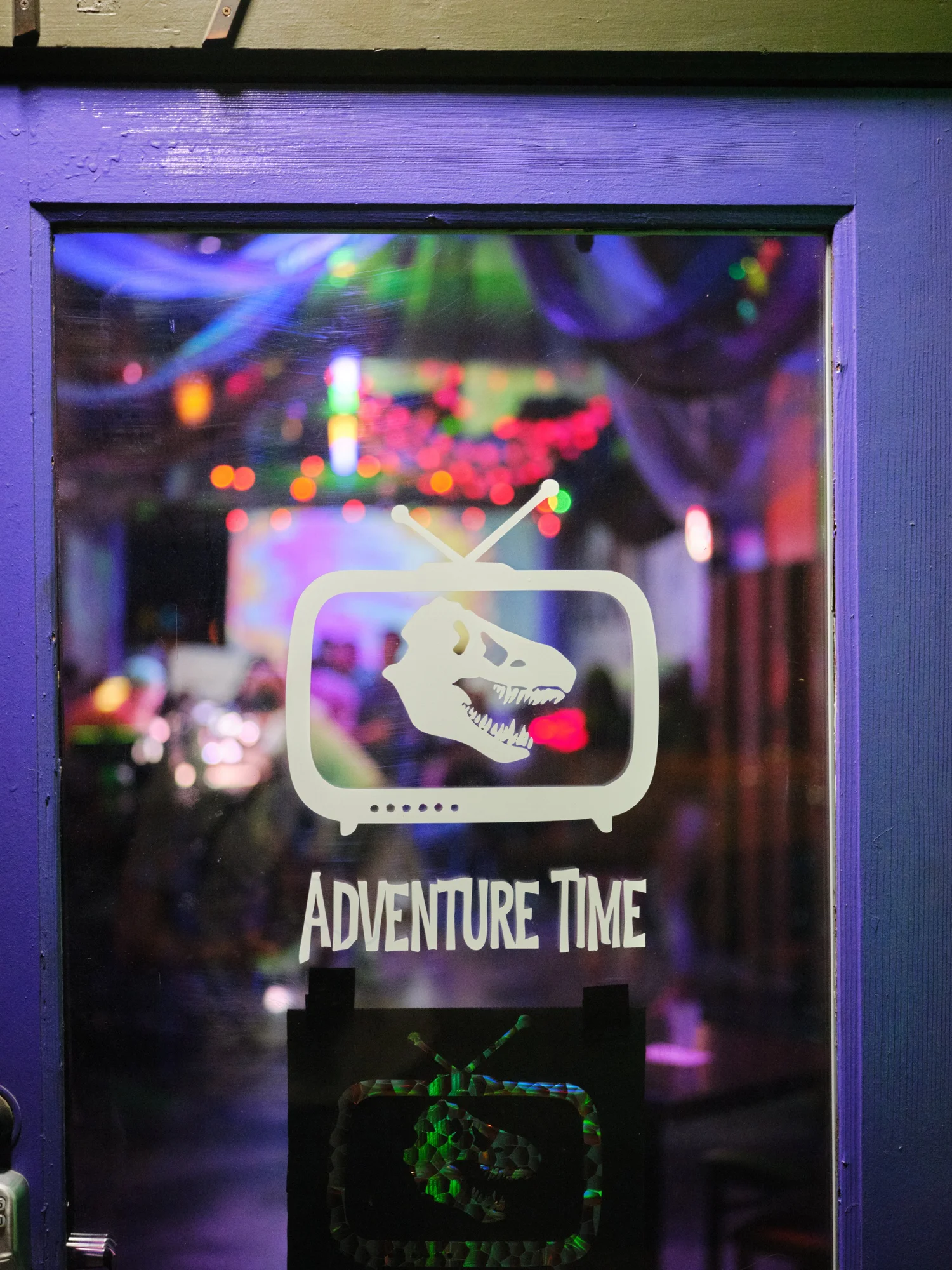 Adventure Time Bar’s entrance, lit with colorful lights