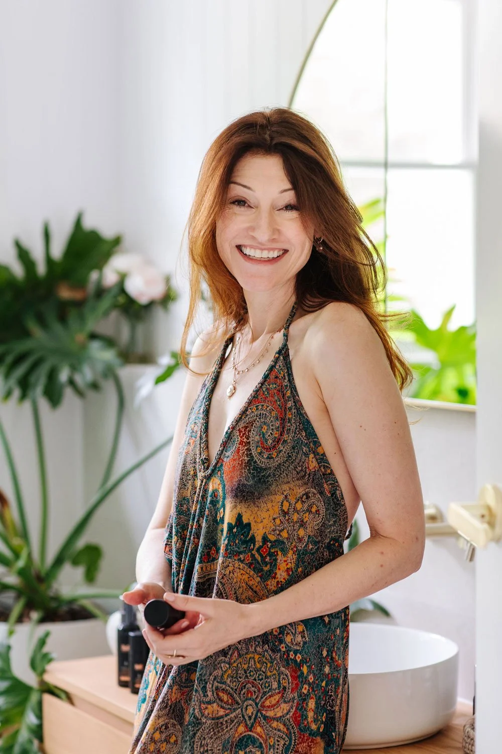 Bec Powne, founder of Jata Holistic in Montville, smiling in a natural light-filled space
