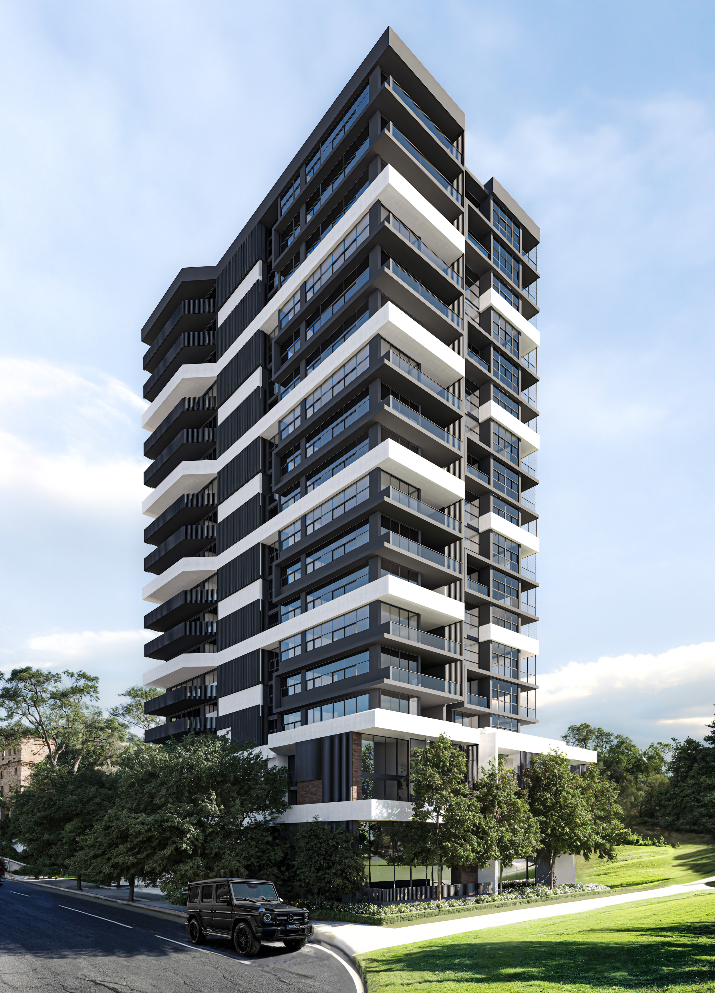 A modern, multi-story residential building with black and white exterior design, large glass windows, and several balconies, situated in a green landscape with trees and a paved road in the foreground, under a partly cloudy sky.
