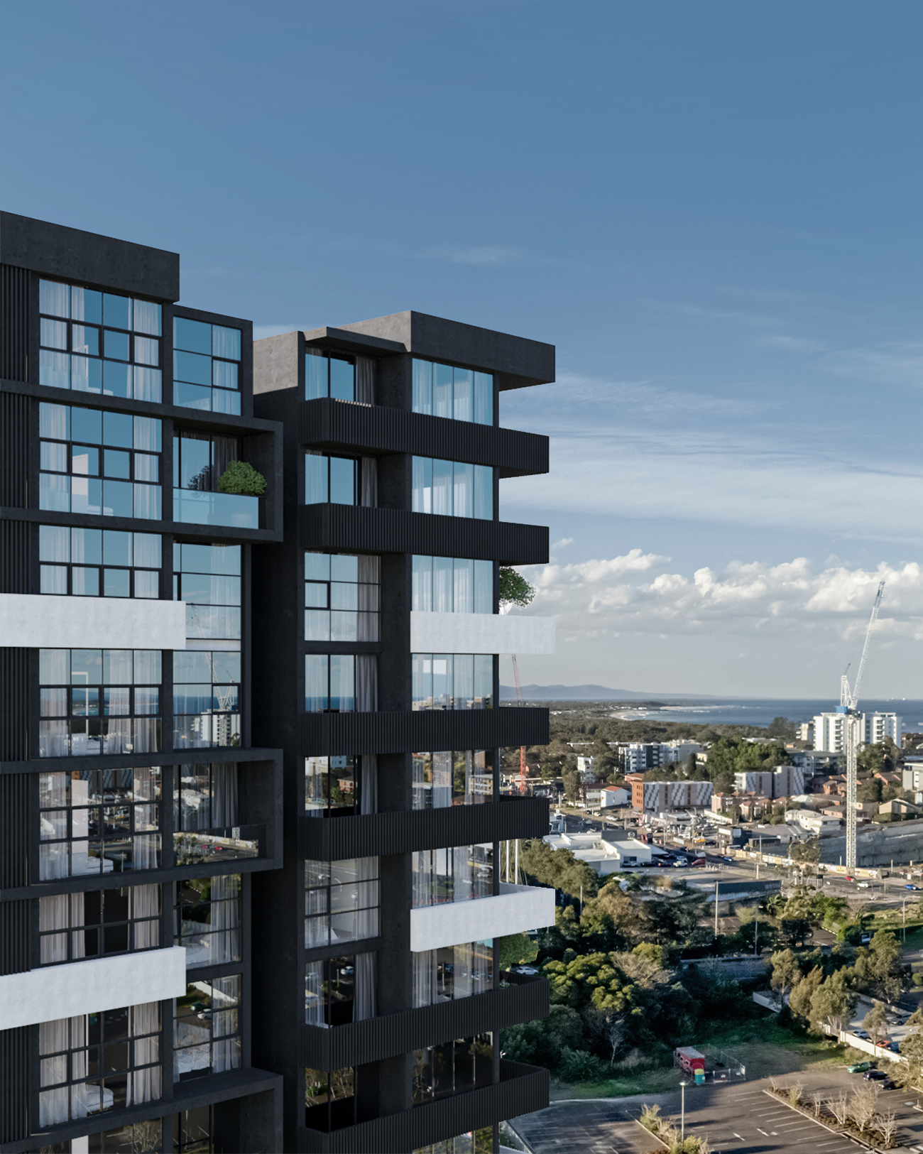 Modern multi-story residential building with glass balconies and black and grey exterior, overlooking urban area and water in the distance under a blue sky.