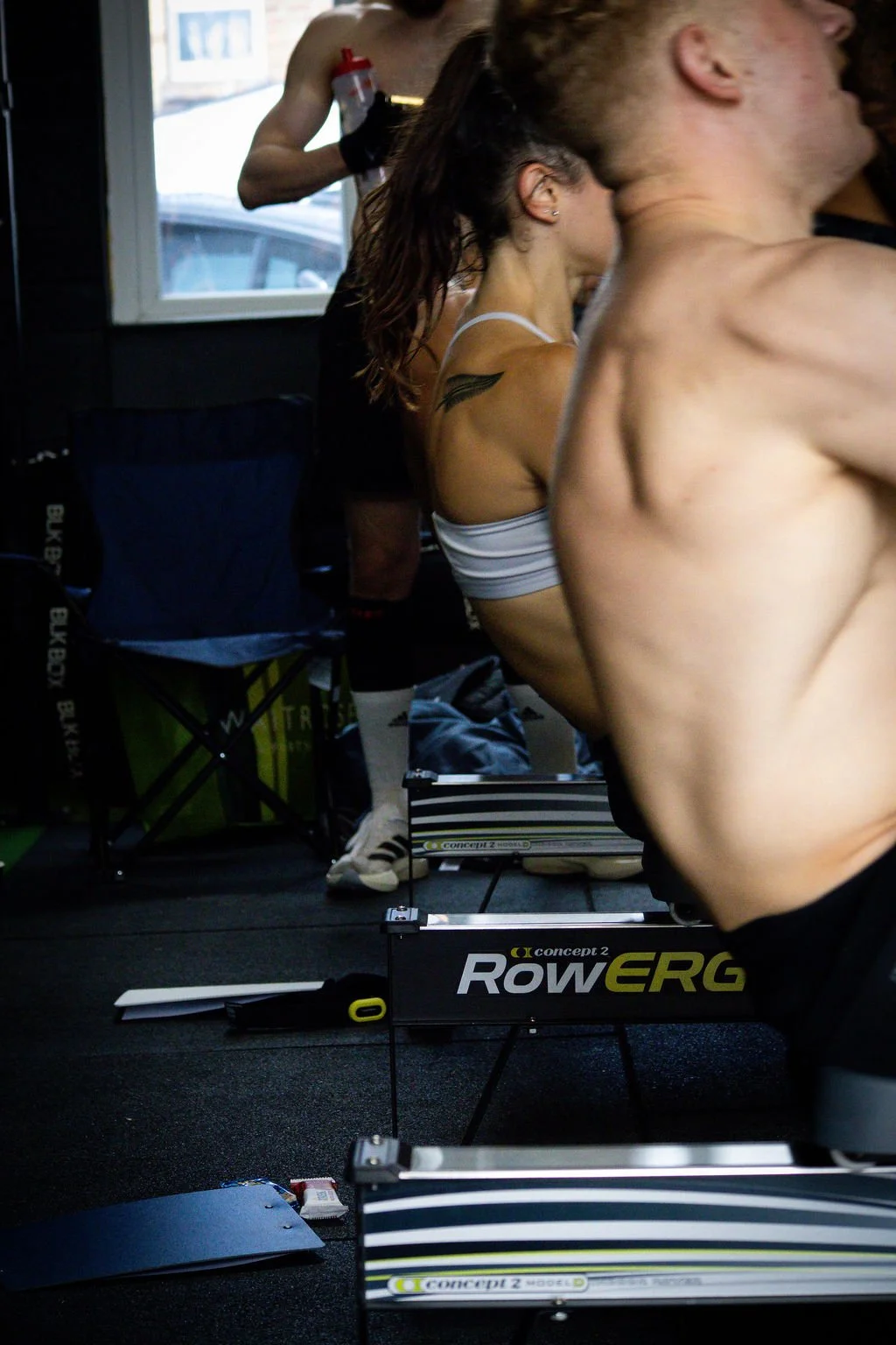 People working out on rowing machines in a gym.