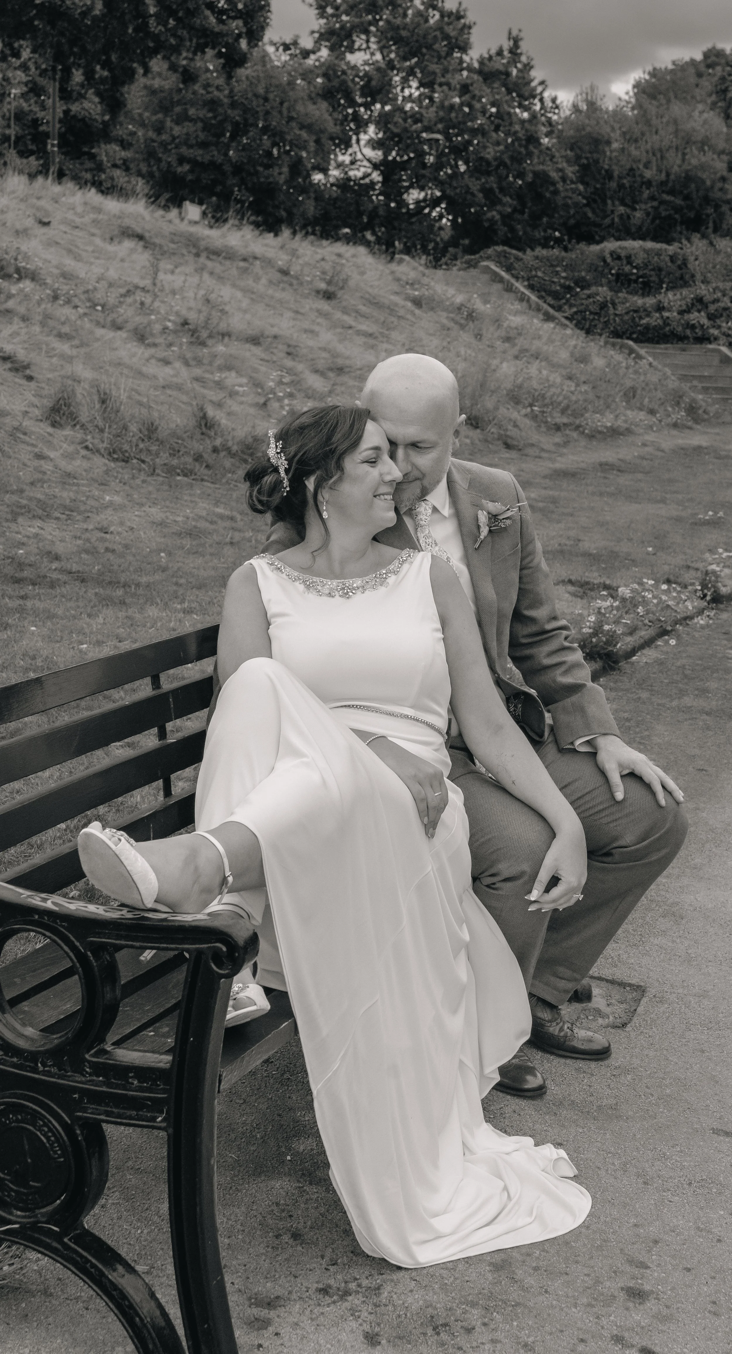 Married couple on a bench in Chesterfield after their wedding.