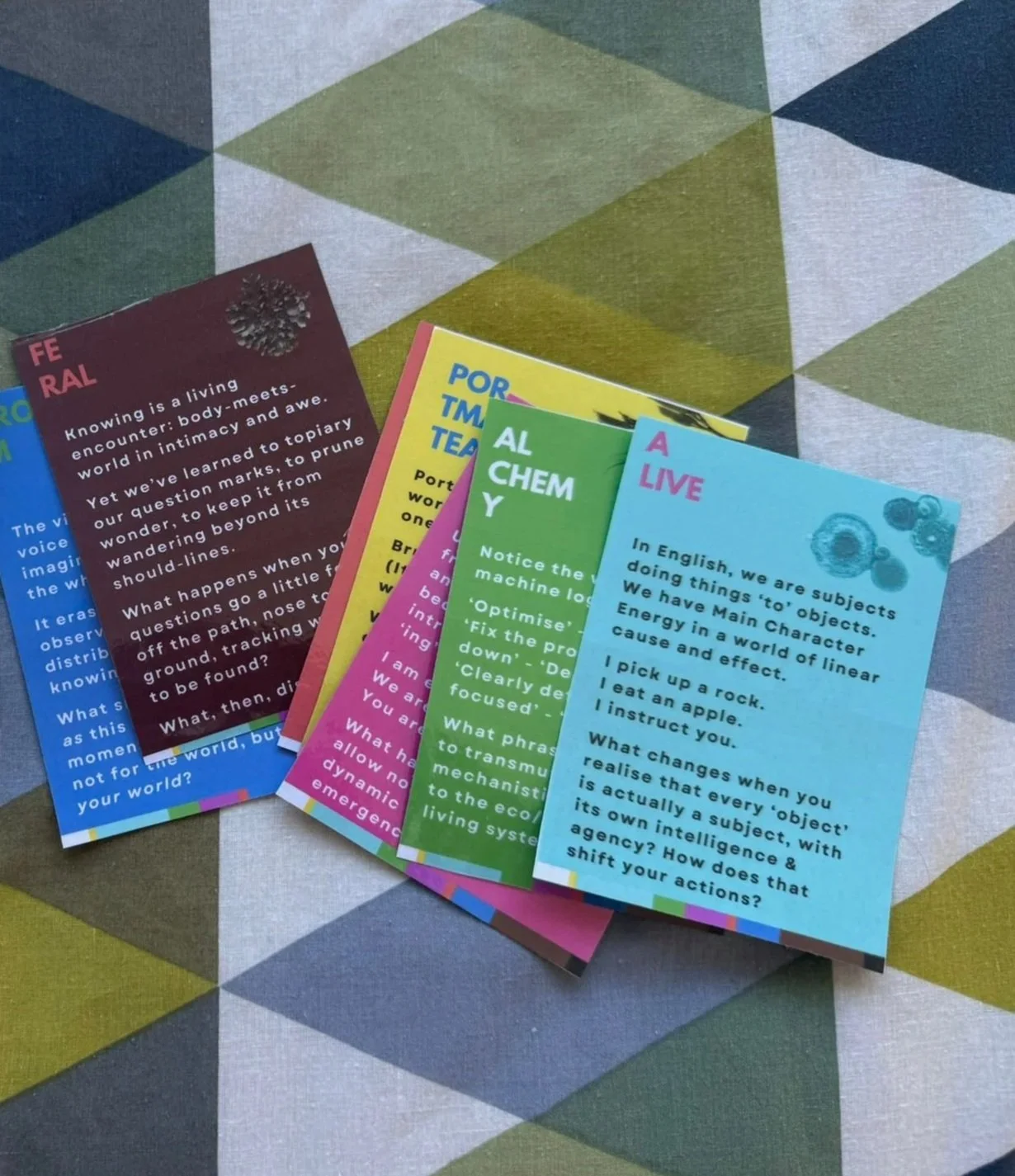 Colorful educational bookmarks arranged on a table with a geometric pattern.