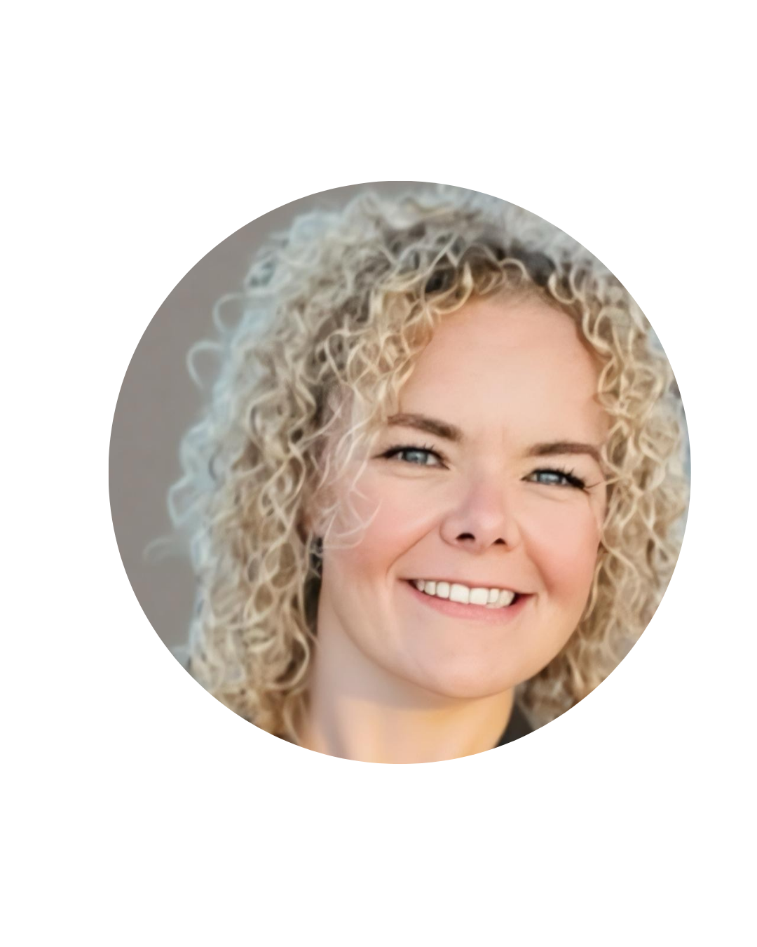 Close-up photograph of a woman with blonde, curly hair, smiling and looking directly at the camera.