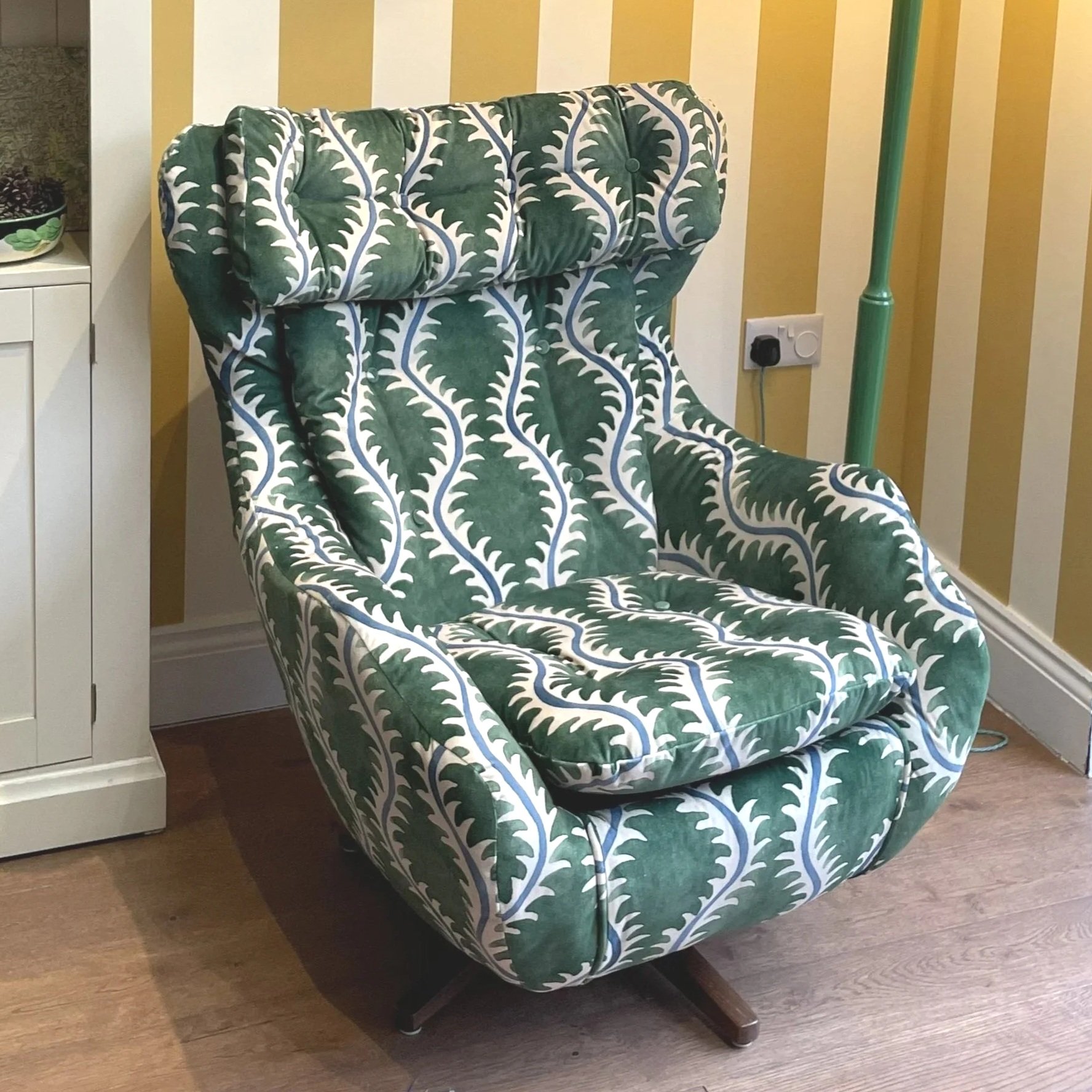 Parker Knoll Statesman chair covered in bright green and white fabric