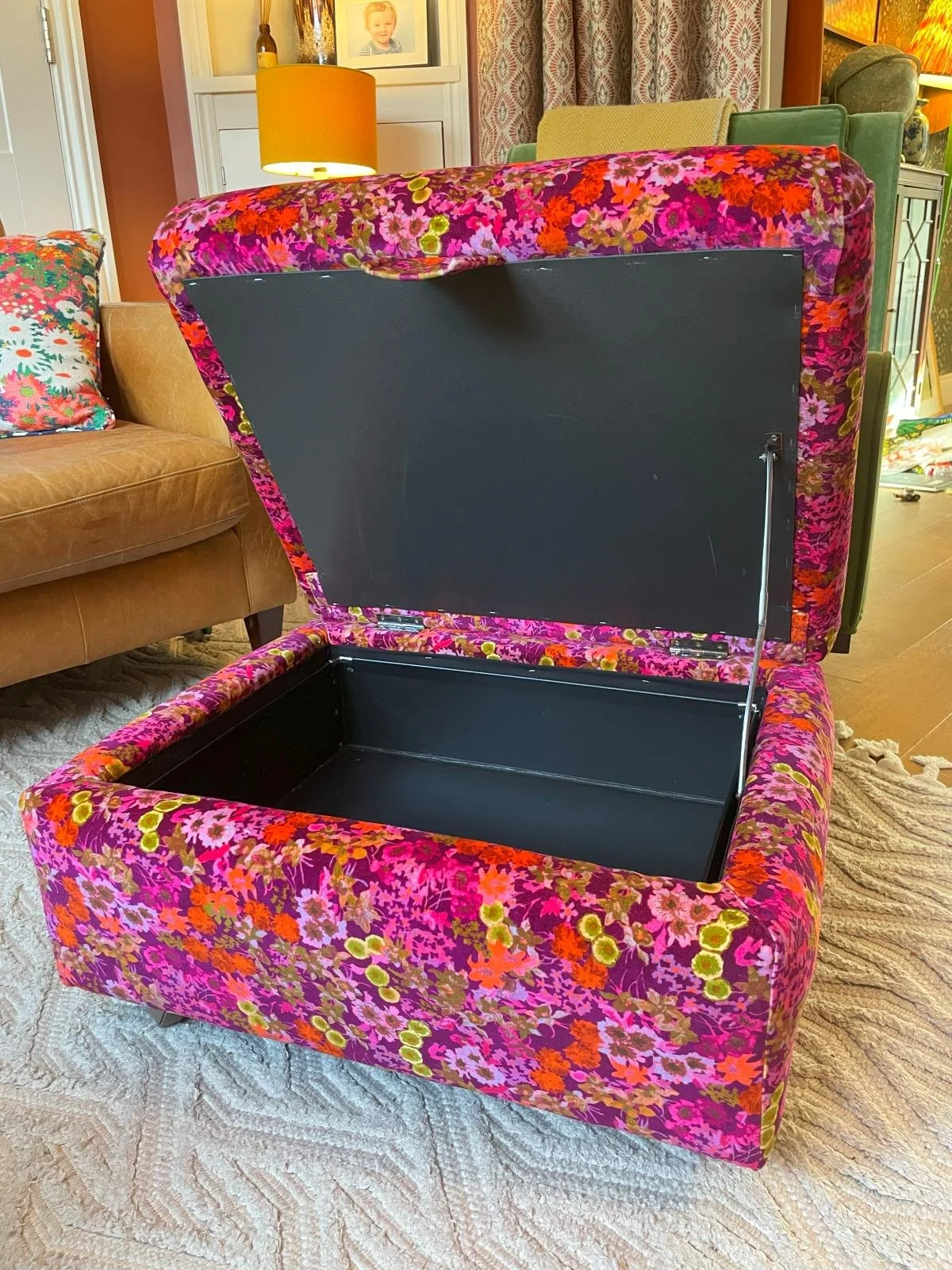 Vintage ottoman (open) reupholstered in bright floral fabric
