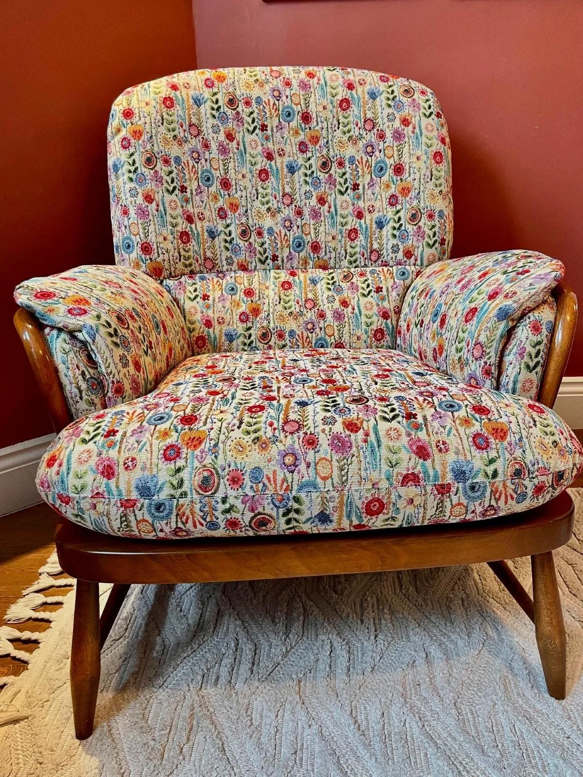 Ercol armchair recovered in floral fabric