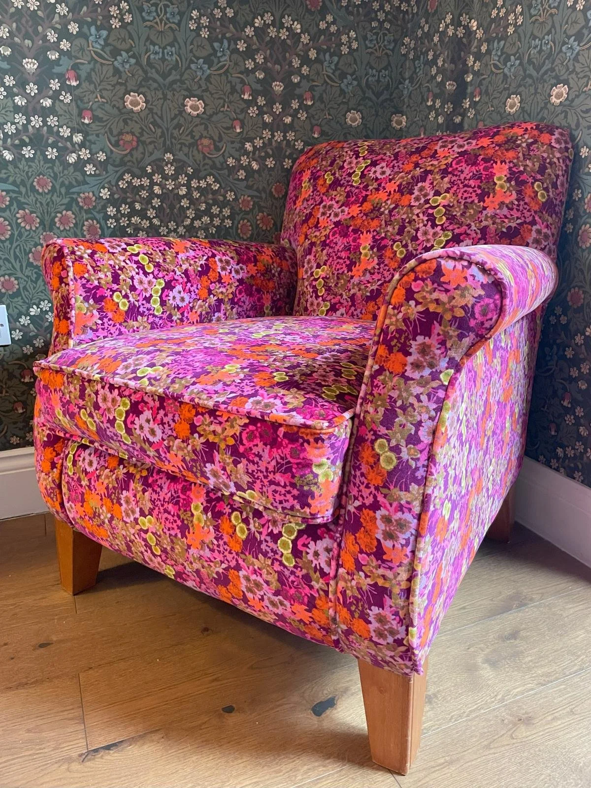 Vintage armchair reupholstered in bright floral fabric