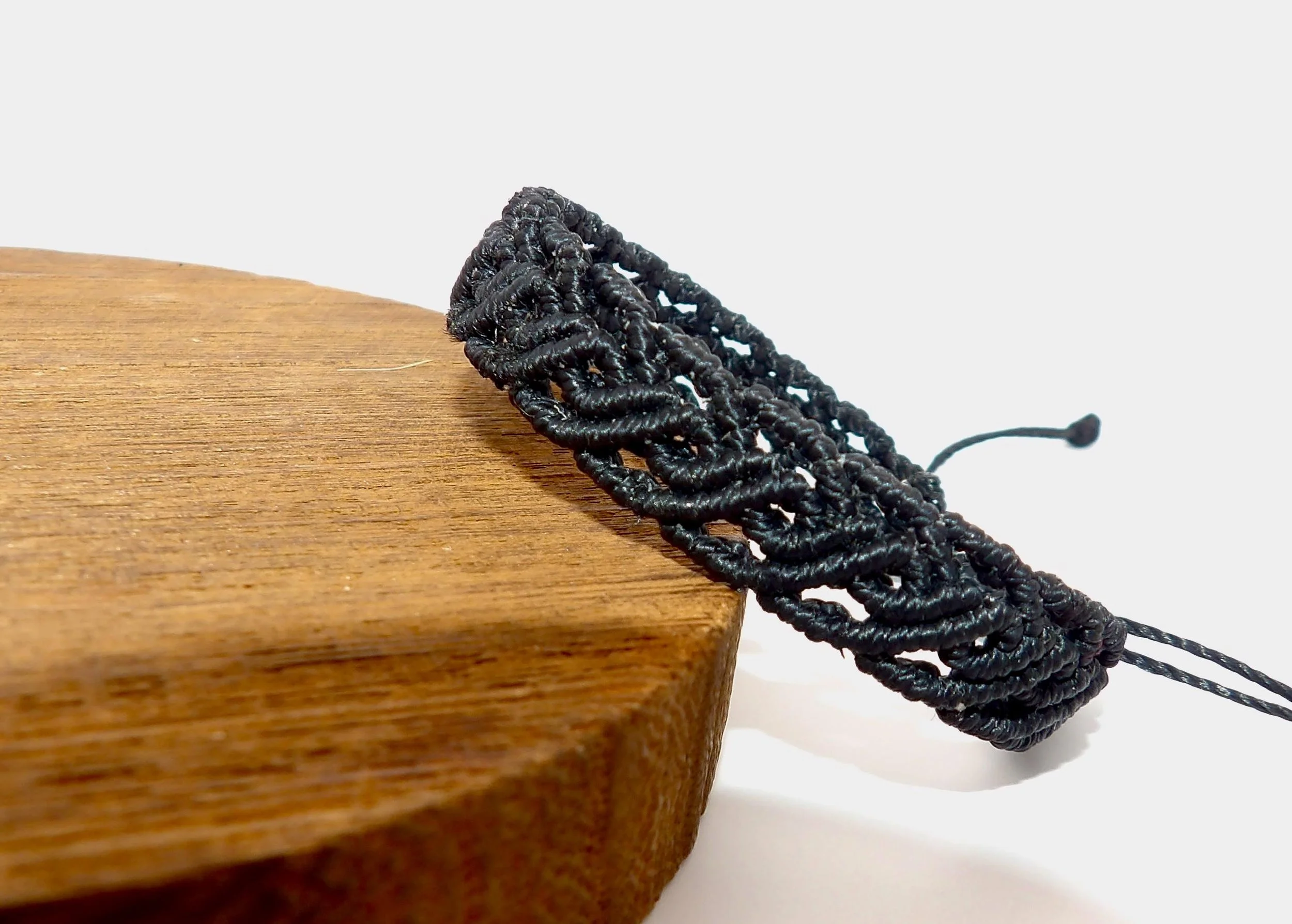 a versatile and lightweight custom-color bracelet featuring a signature scalloped scrollwork edge for a feminine, artisanal look.