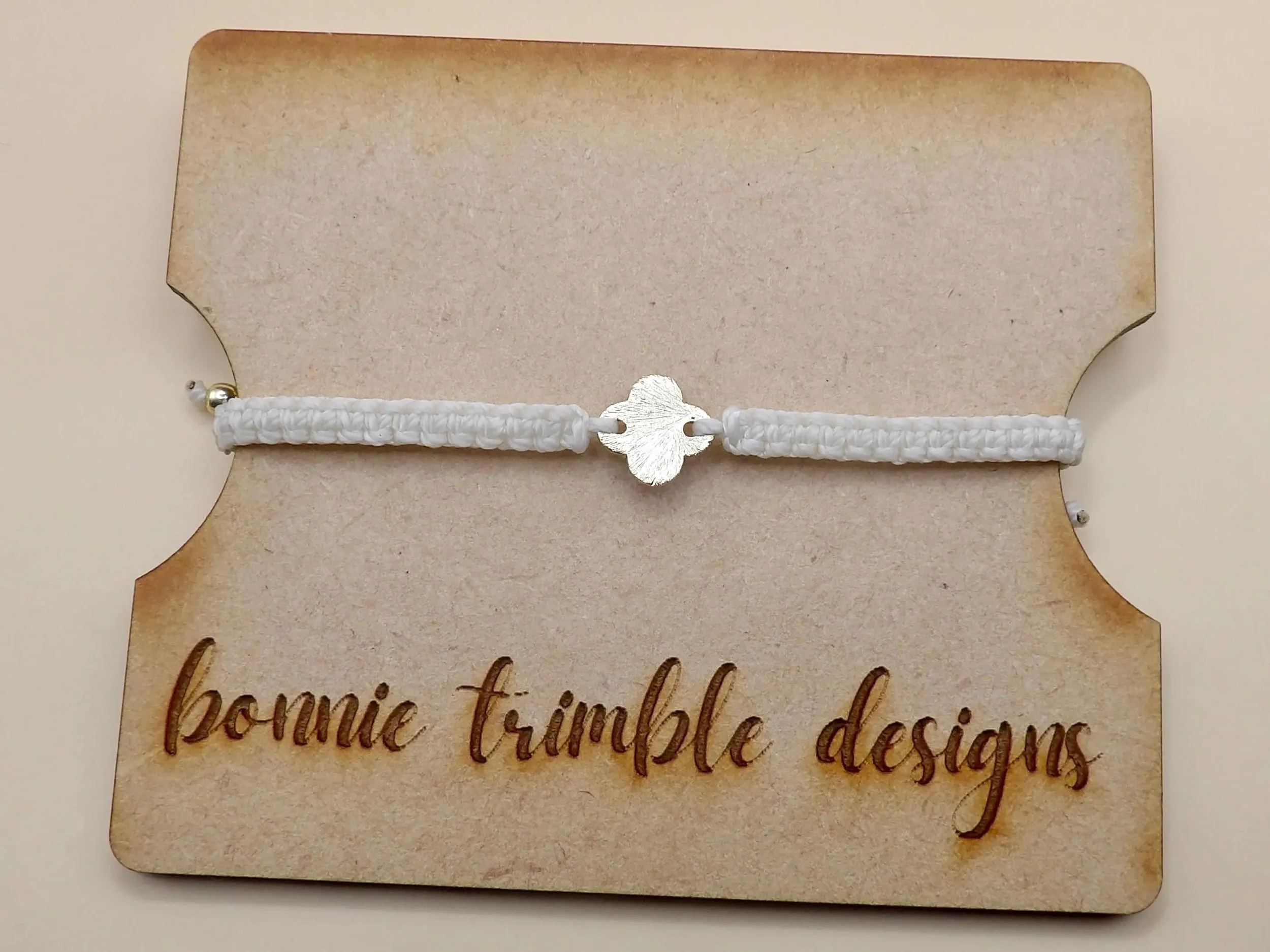 an elegant and low-profile religious lifestyle bracelet designed for daily wear, styled on an organic linen background.