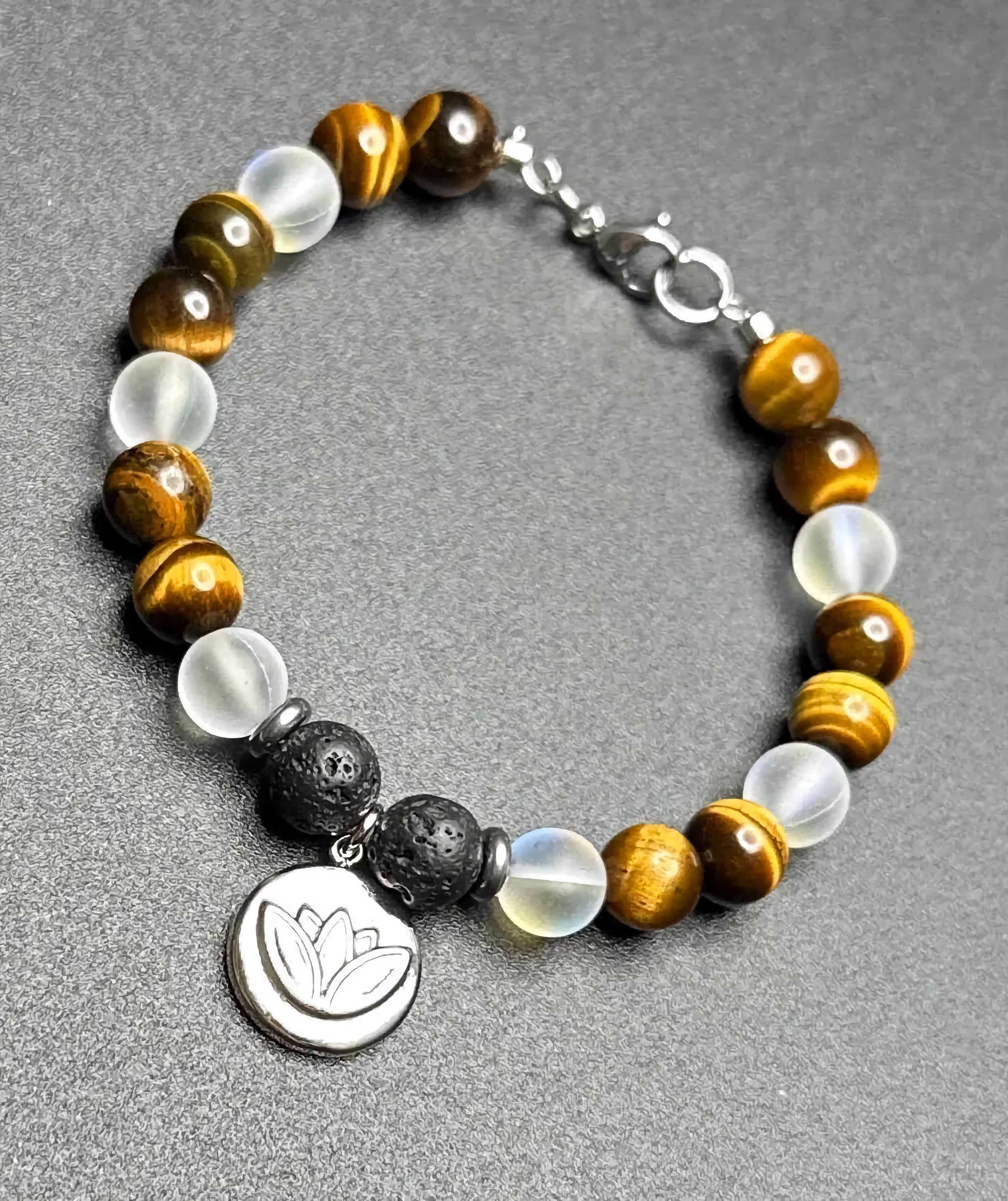 A close-up of a handmade chakra bracelet with 7 different colored gemstones.