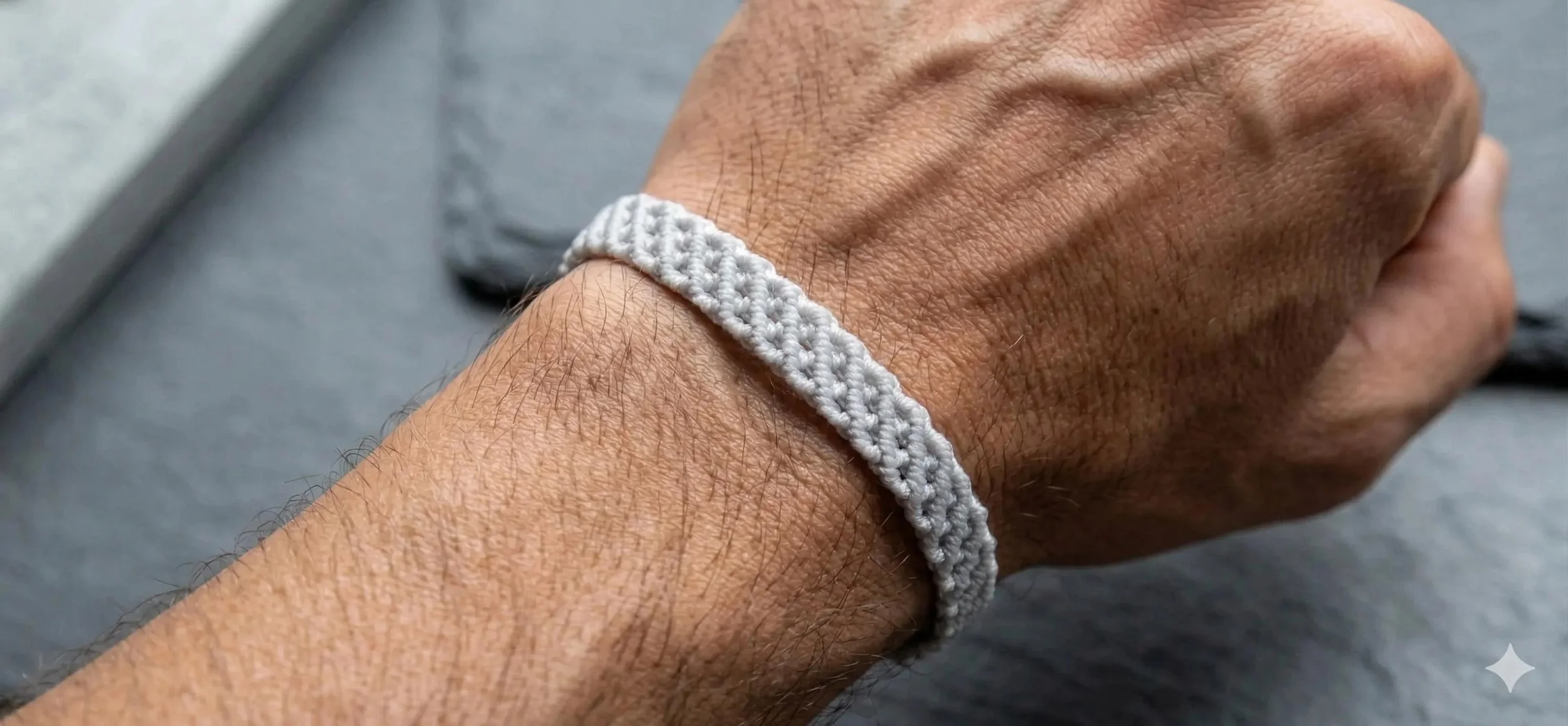 a precision-crafted industrial minimalist bracelet showing the dense, fabric-like texture of ultra-fine gray cord.