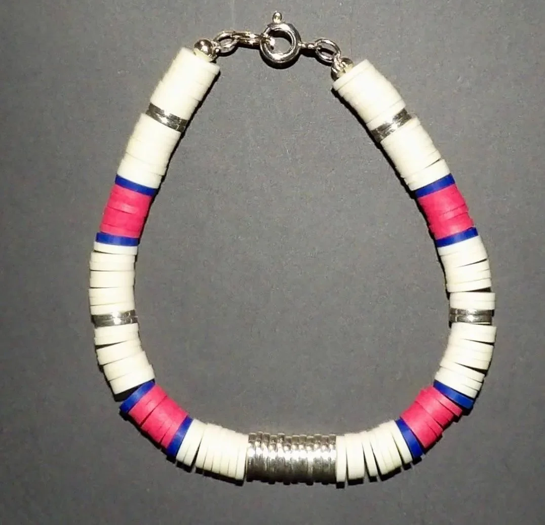 close-up of the preppy trendsetter bracelet showing the matte texture of the clay heishi beads and the reflective shine of silver hematite.